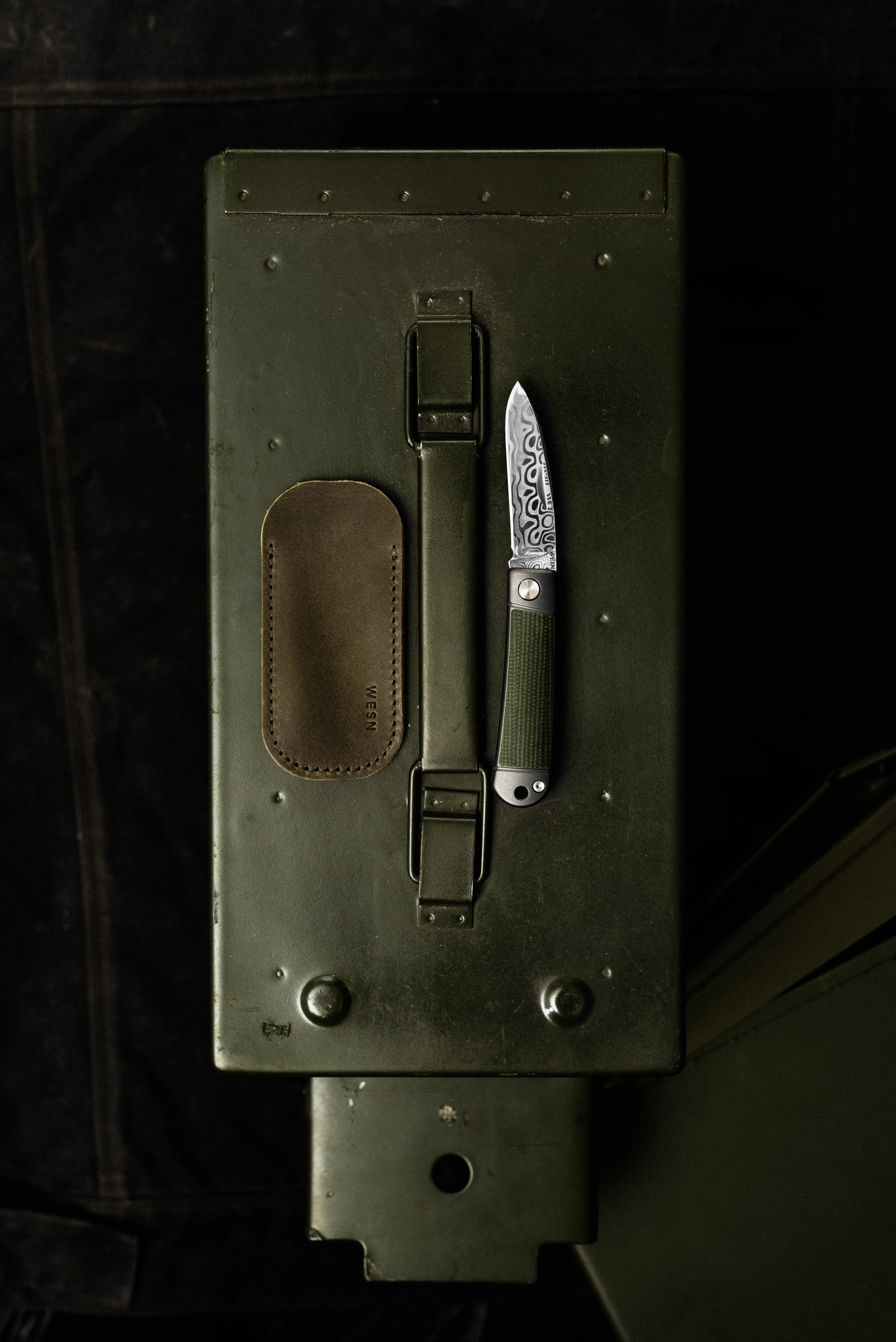 wesn founder's line henry  knife on a green toolbox