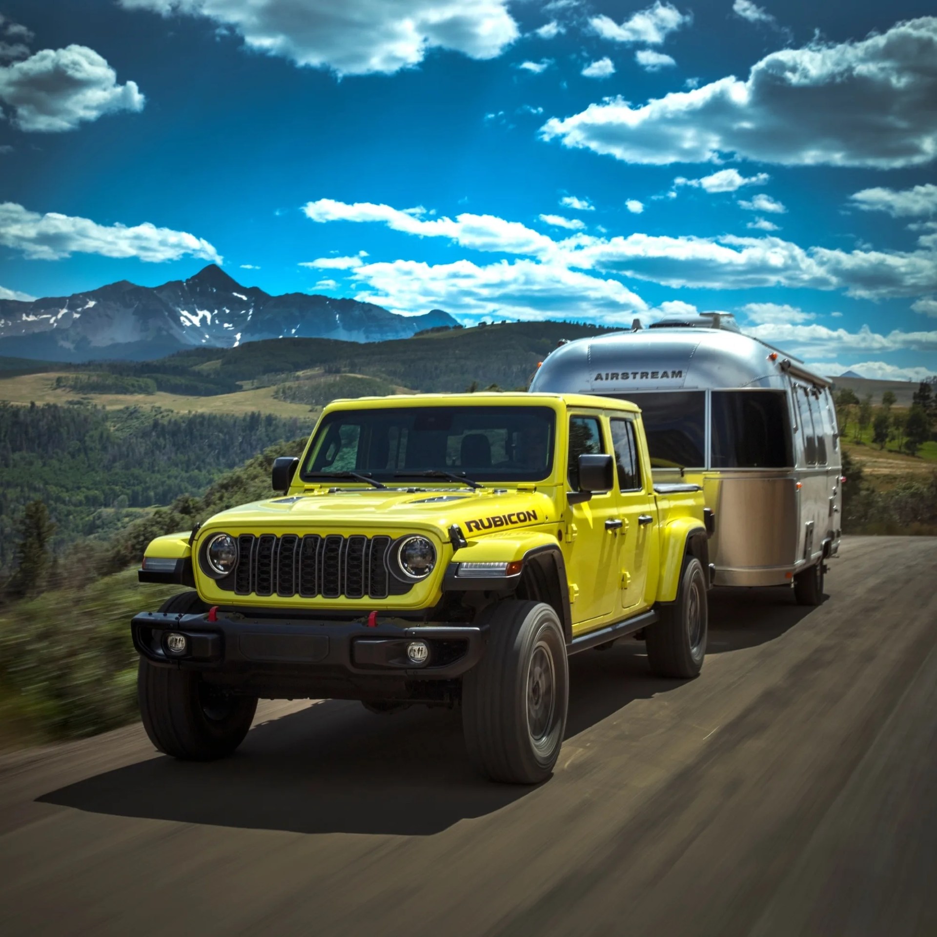 jeep gladiator towing a trailer in a rural area