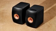 Black speakers on plywood table