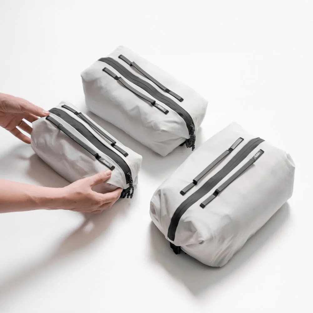 Three matador gear cubes in white zipped up on table
