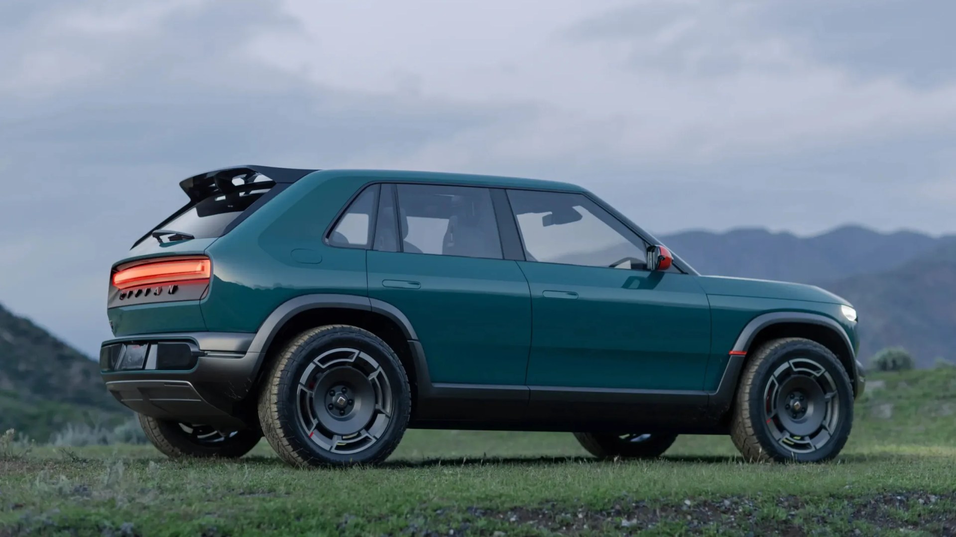 Rivian R3X parked on grass