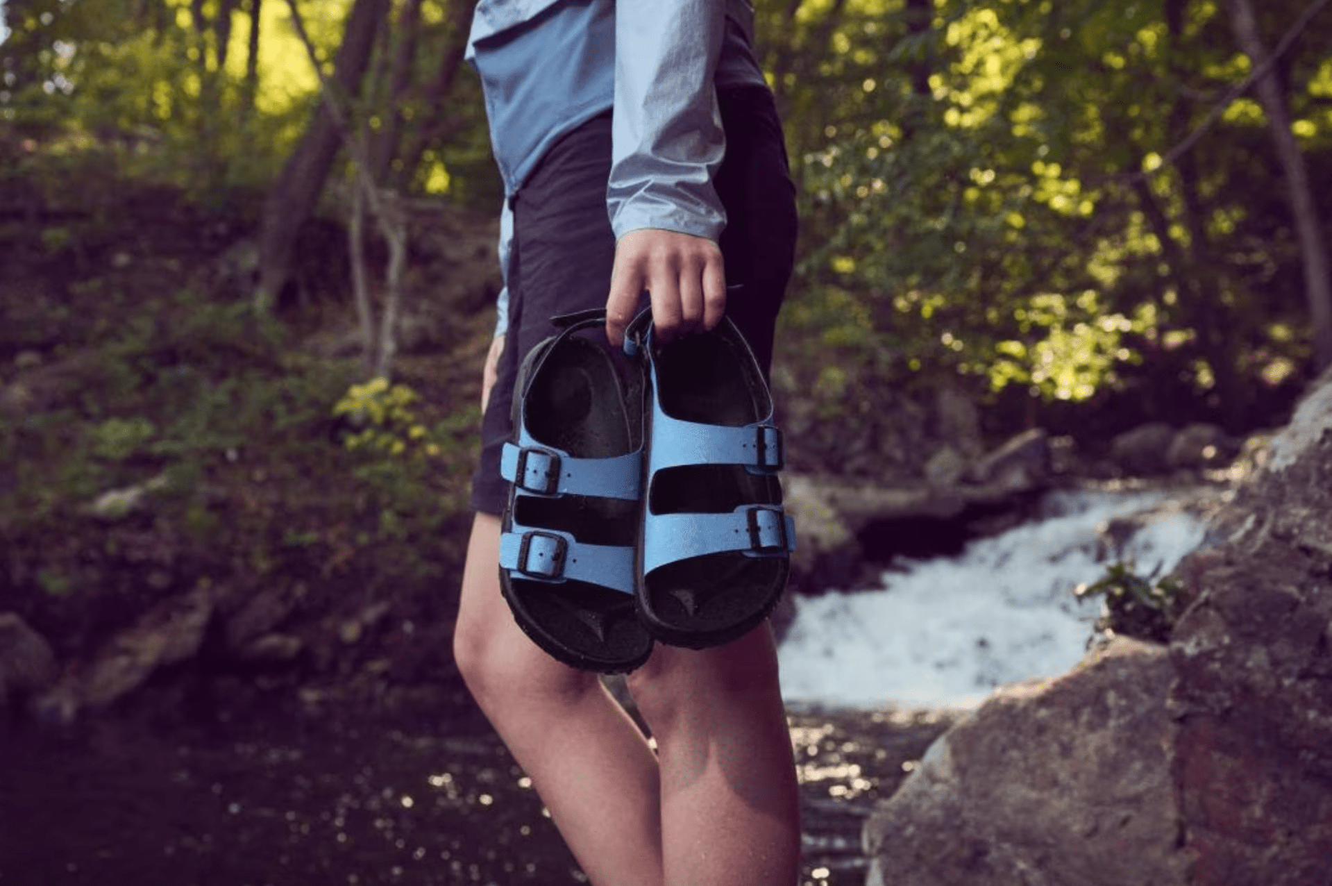 woman holding birkenstock mogami terra sandals