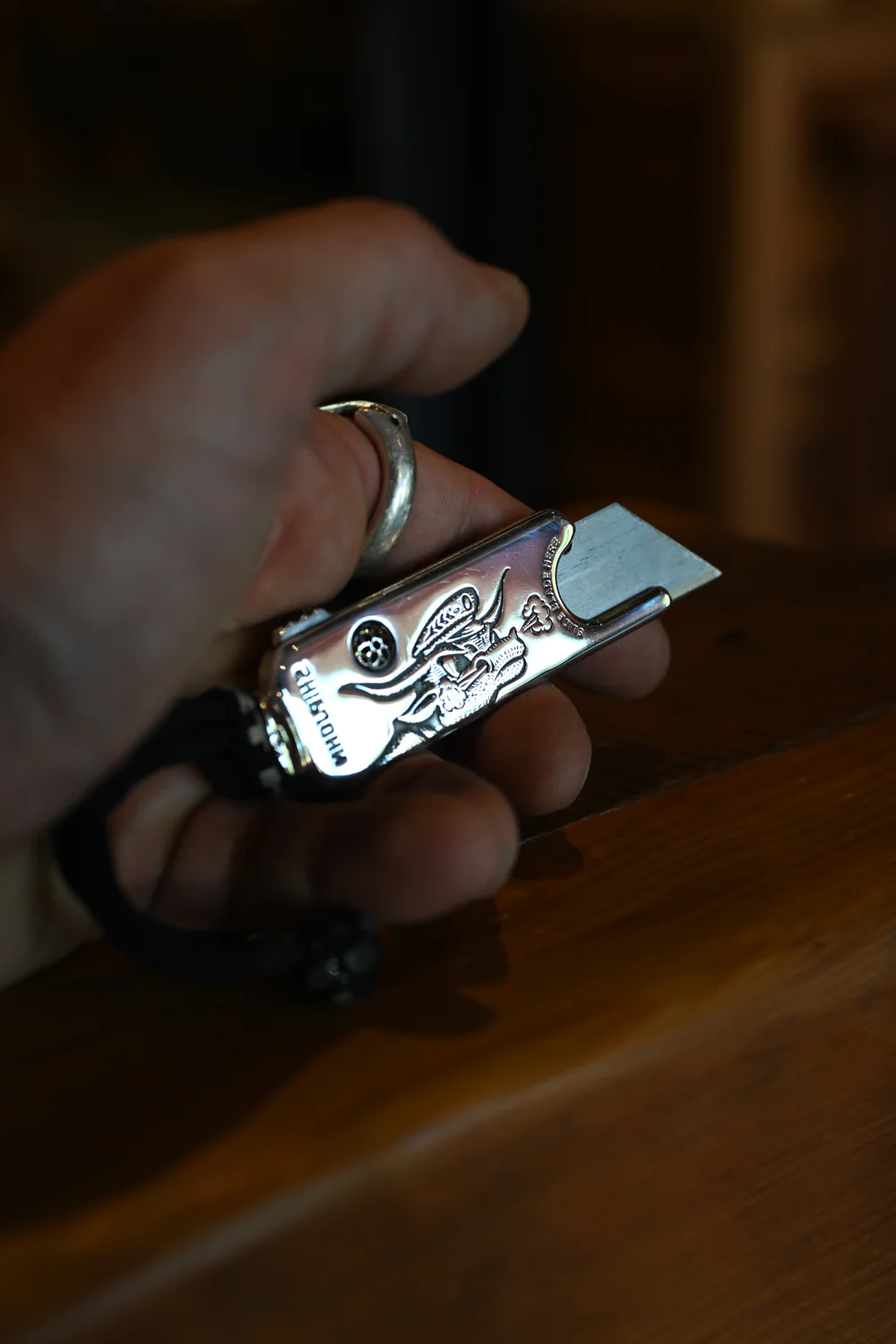 A hand holding a sterling silver utility knife from Ship John