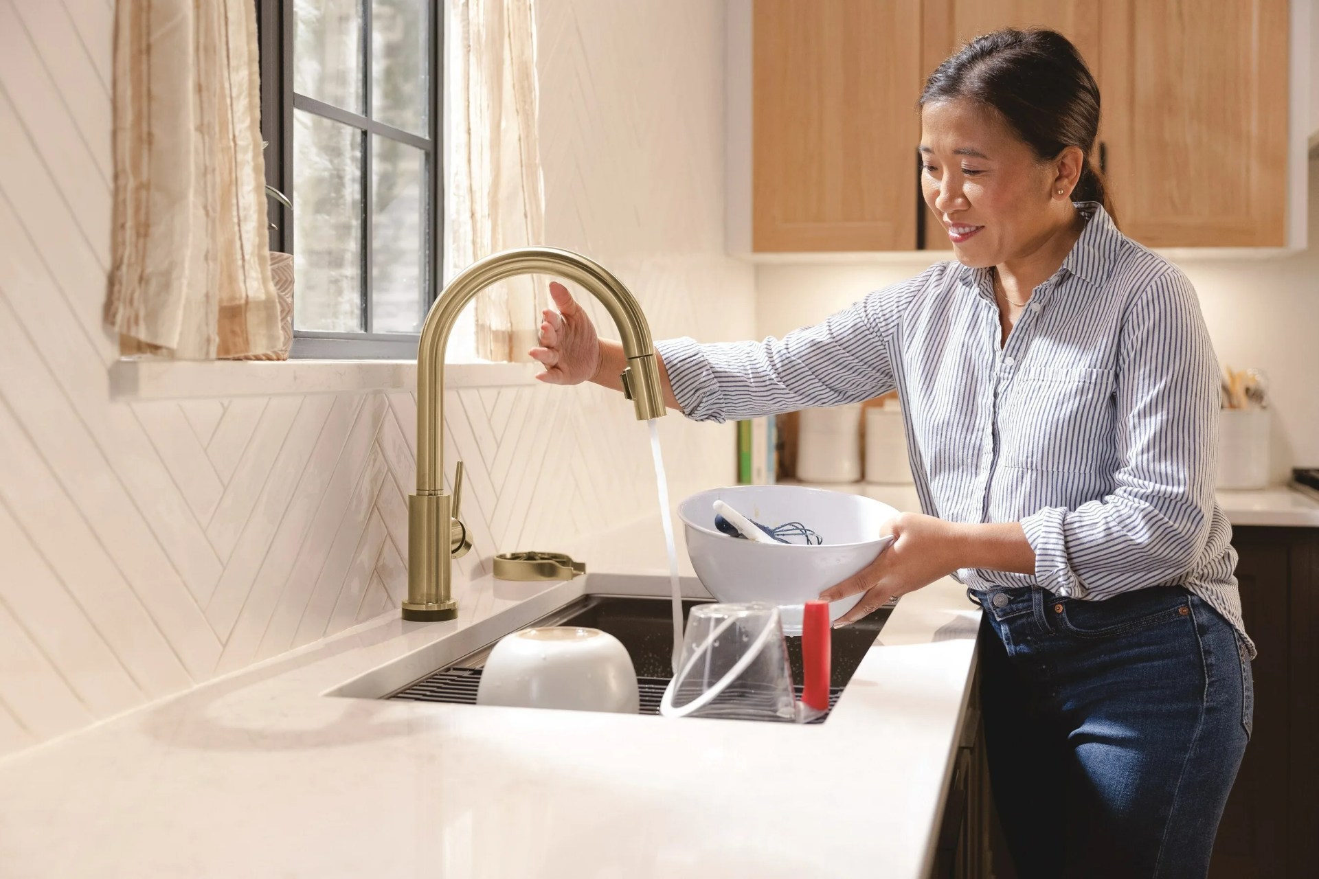 woman using delta Touchless Kitchen Faucet