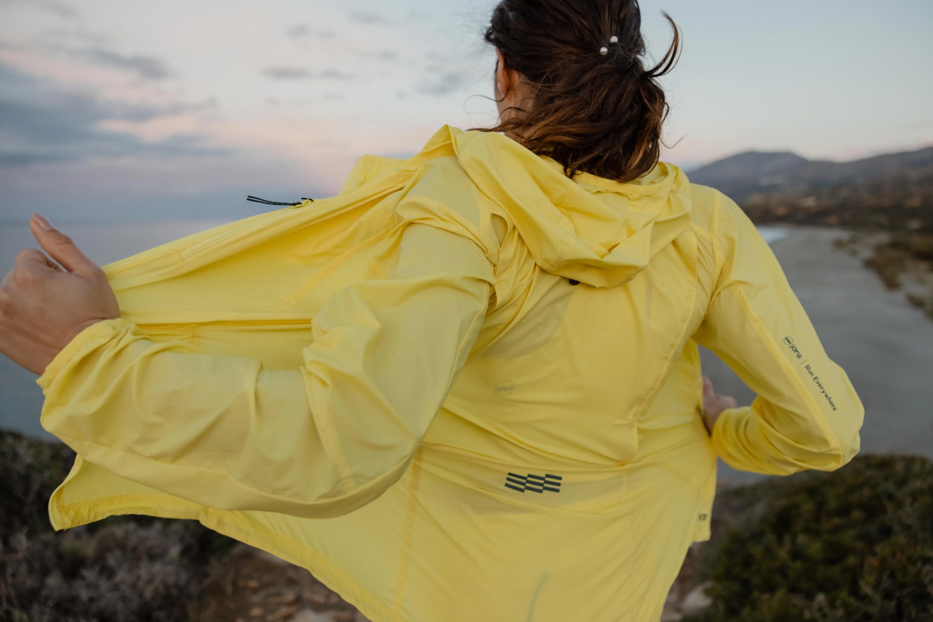woman running in yellow running jacket