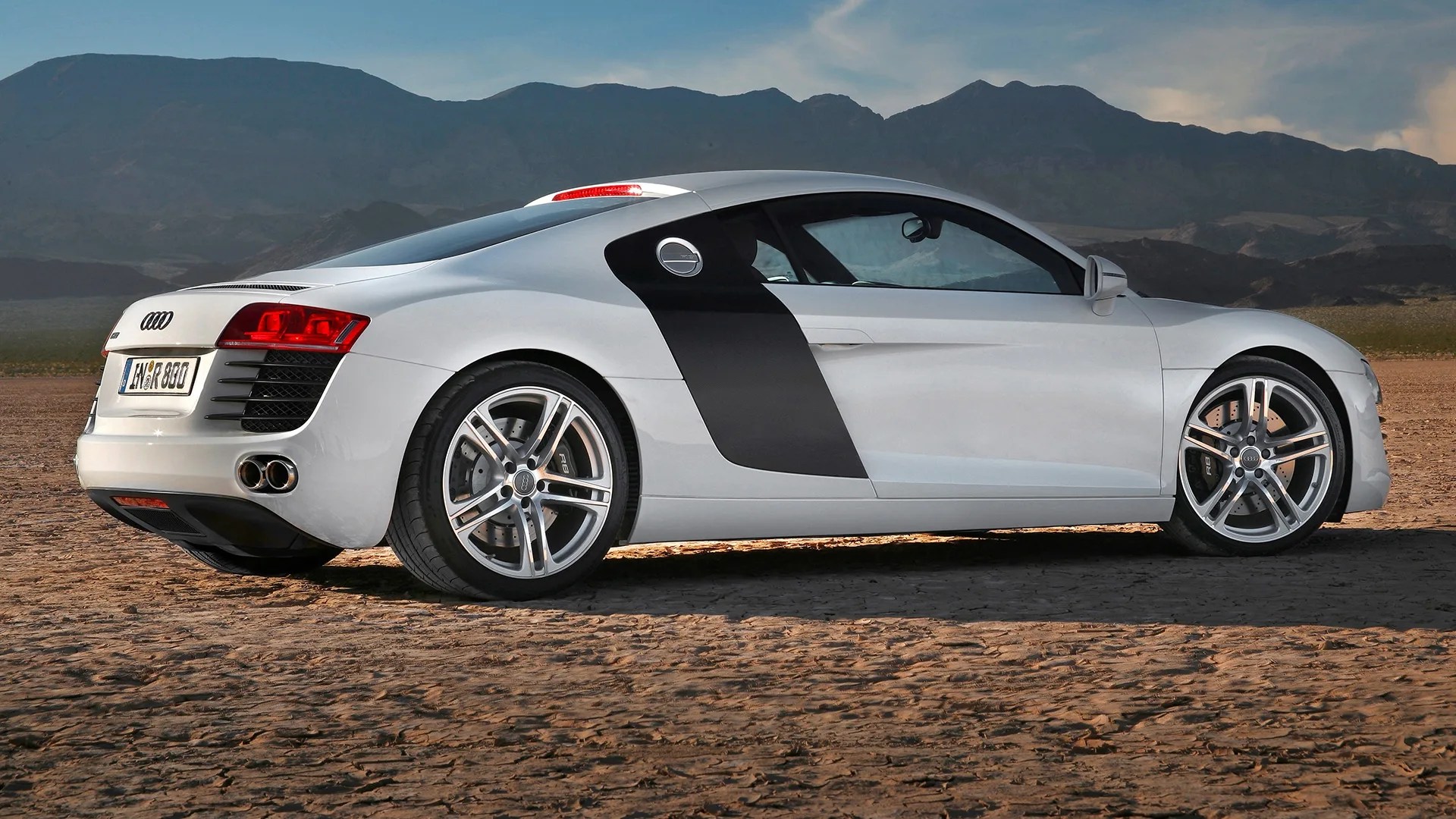 silver first generation audi r8 sports car seen from a rear three quarter view