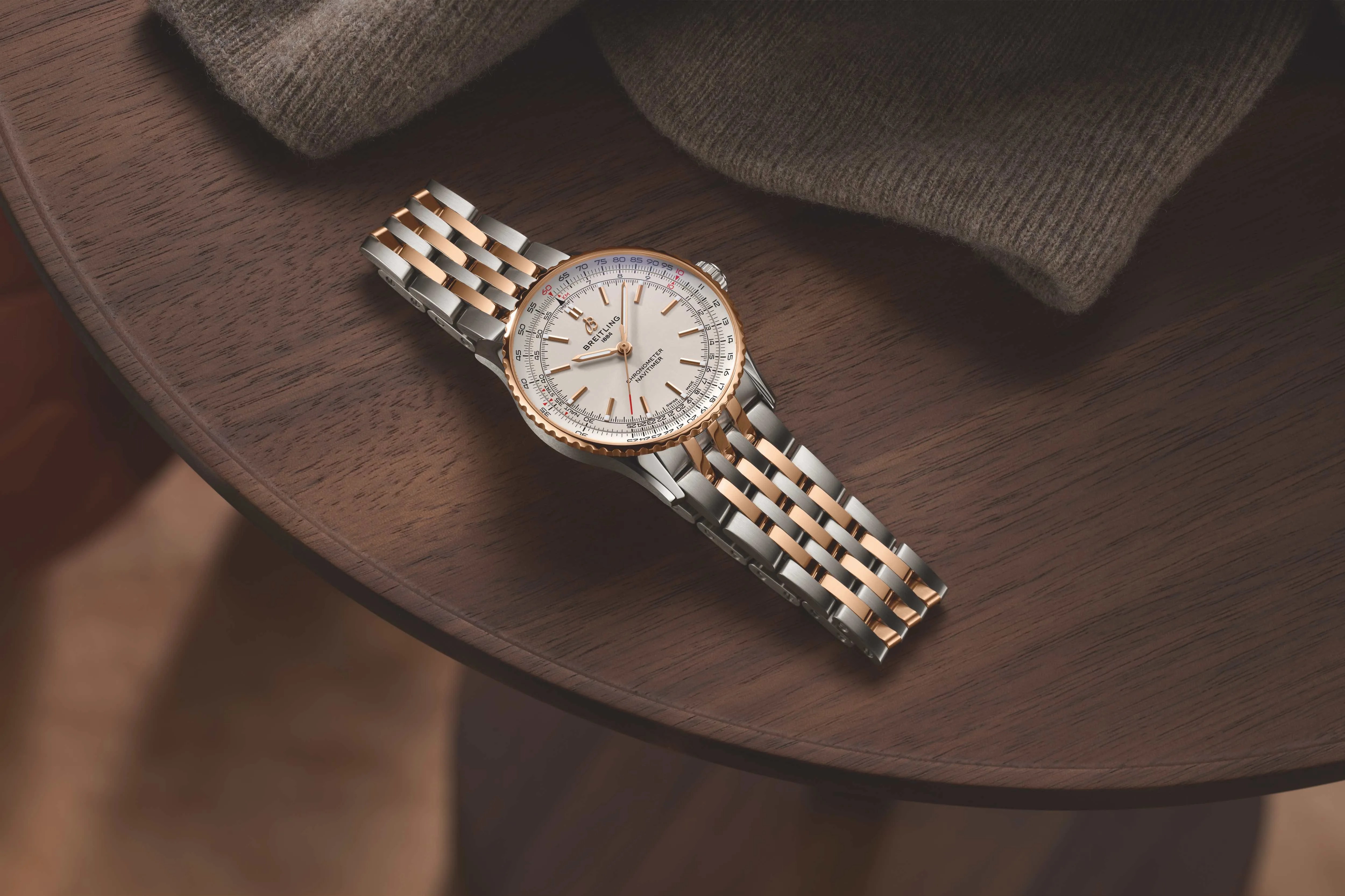 two tone breitling watch on a table