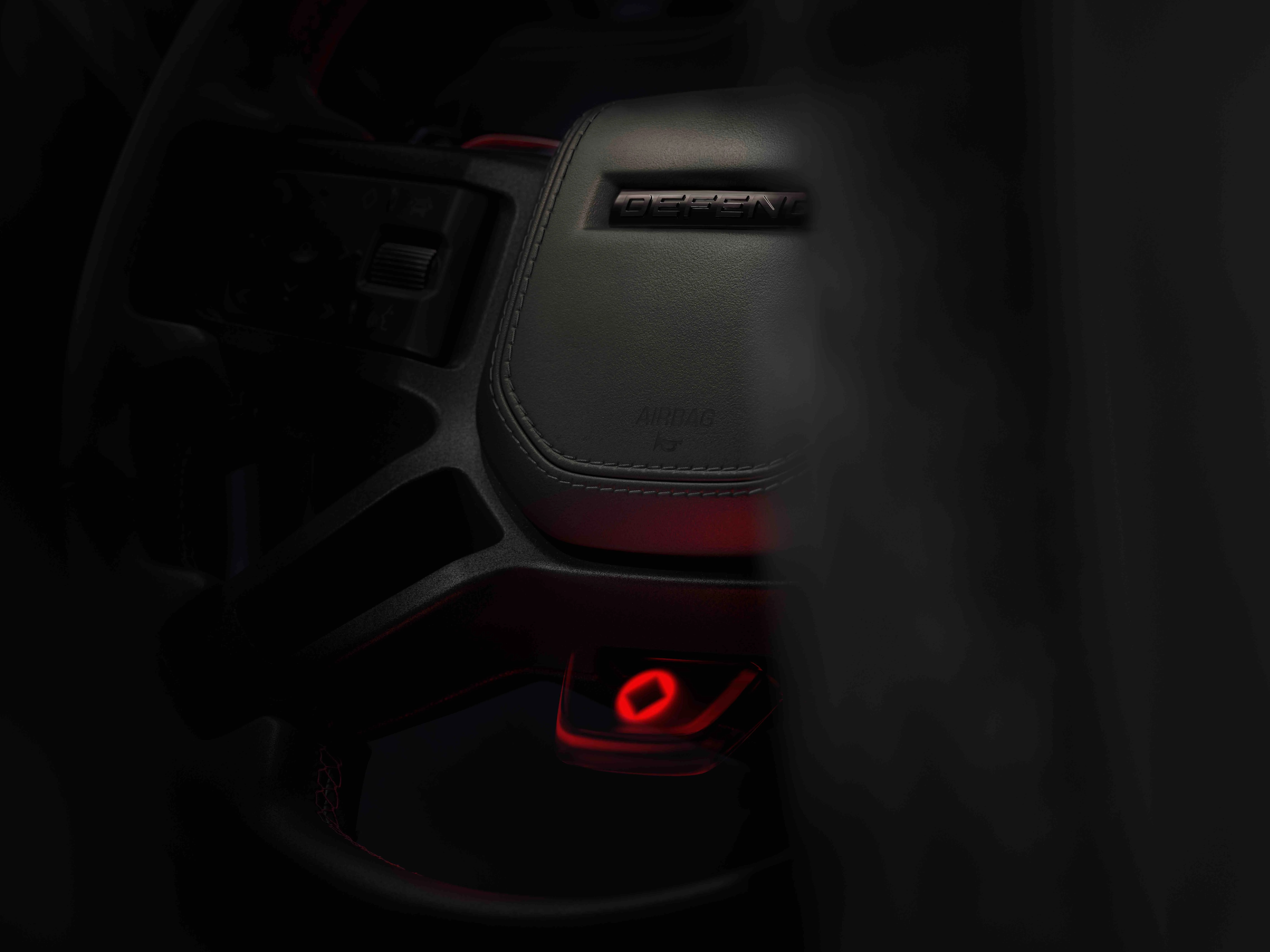 a closeup of a land rover defender steering wheel