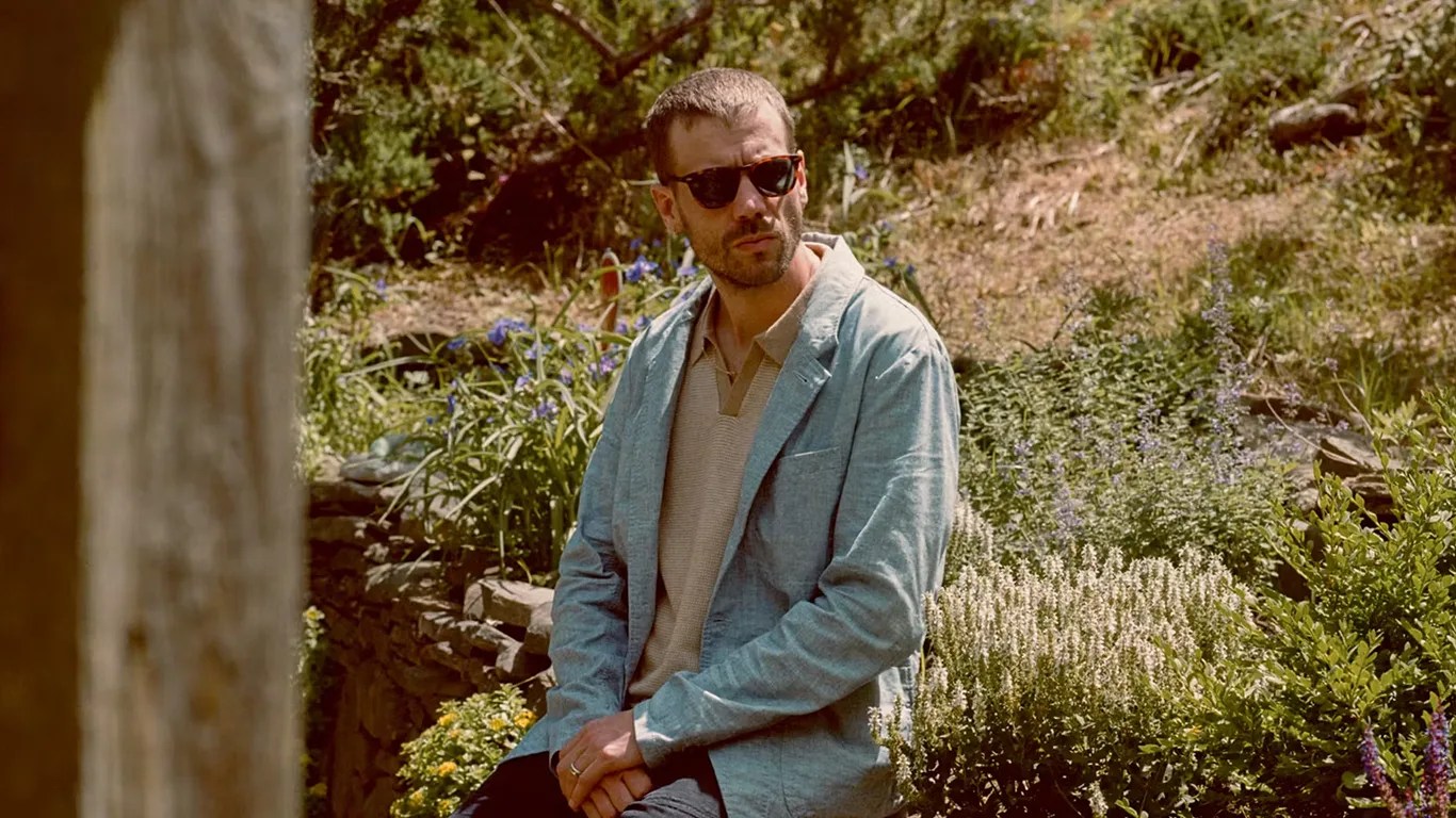 a man wearing a relwen blazer outside in the summer