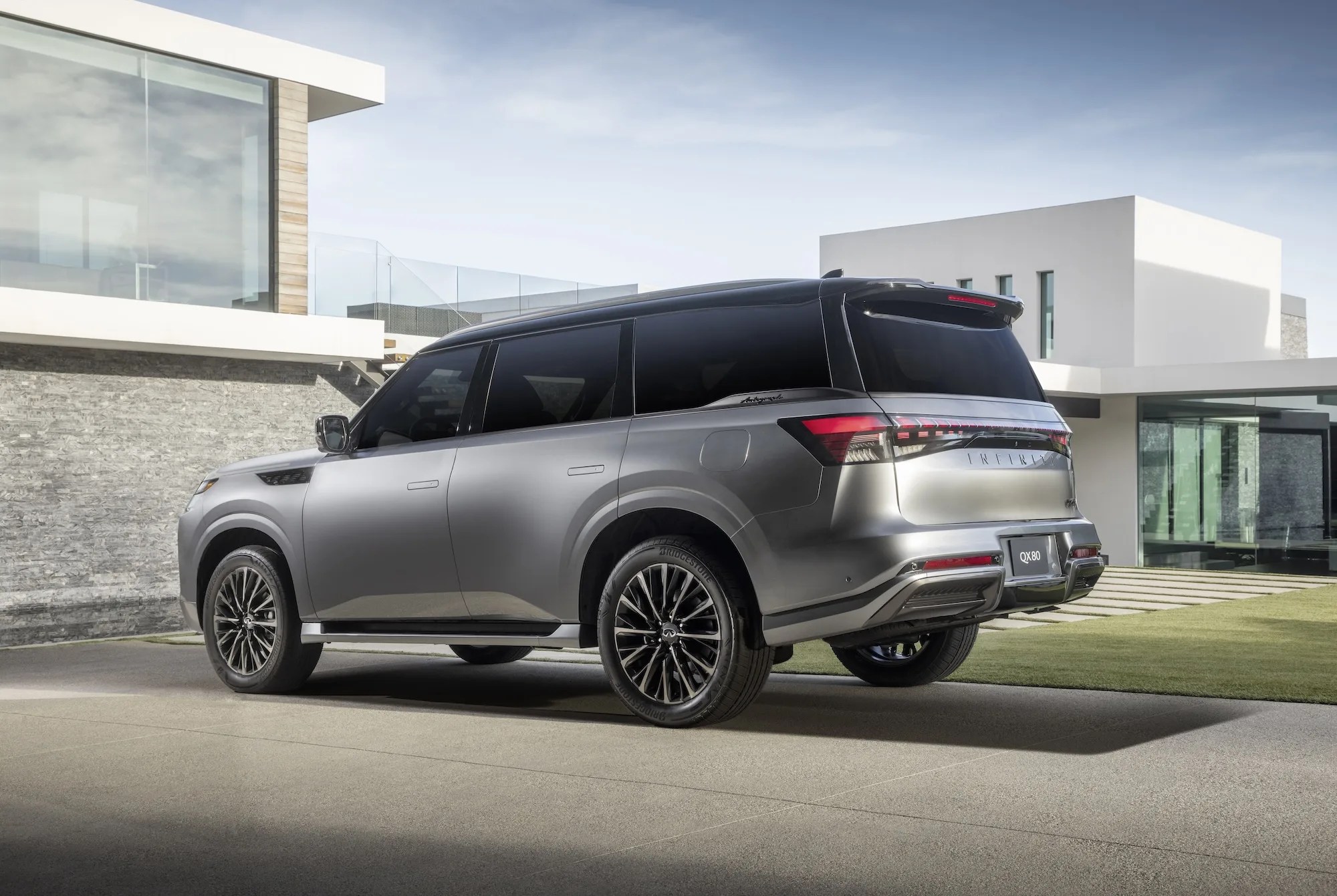 Infiniti QX80 parked in a modern driveway