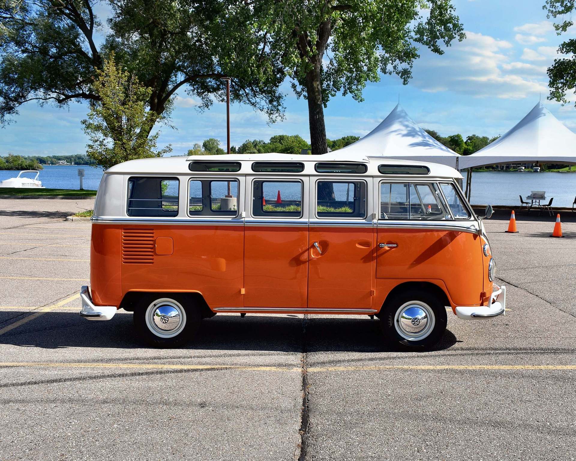 VW Bus from the side in a parking lot by a lake