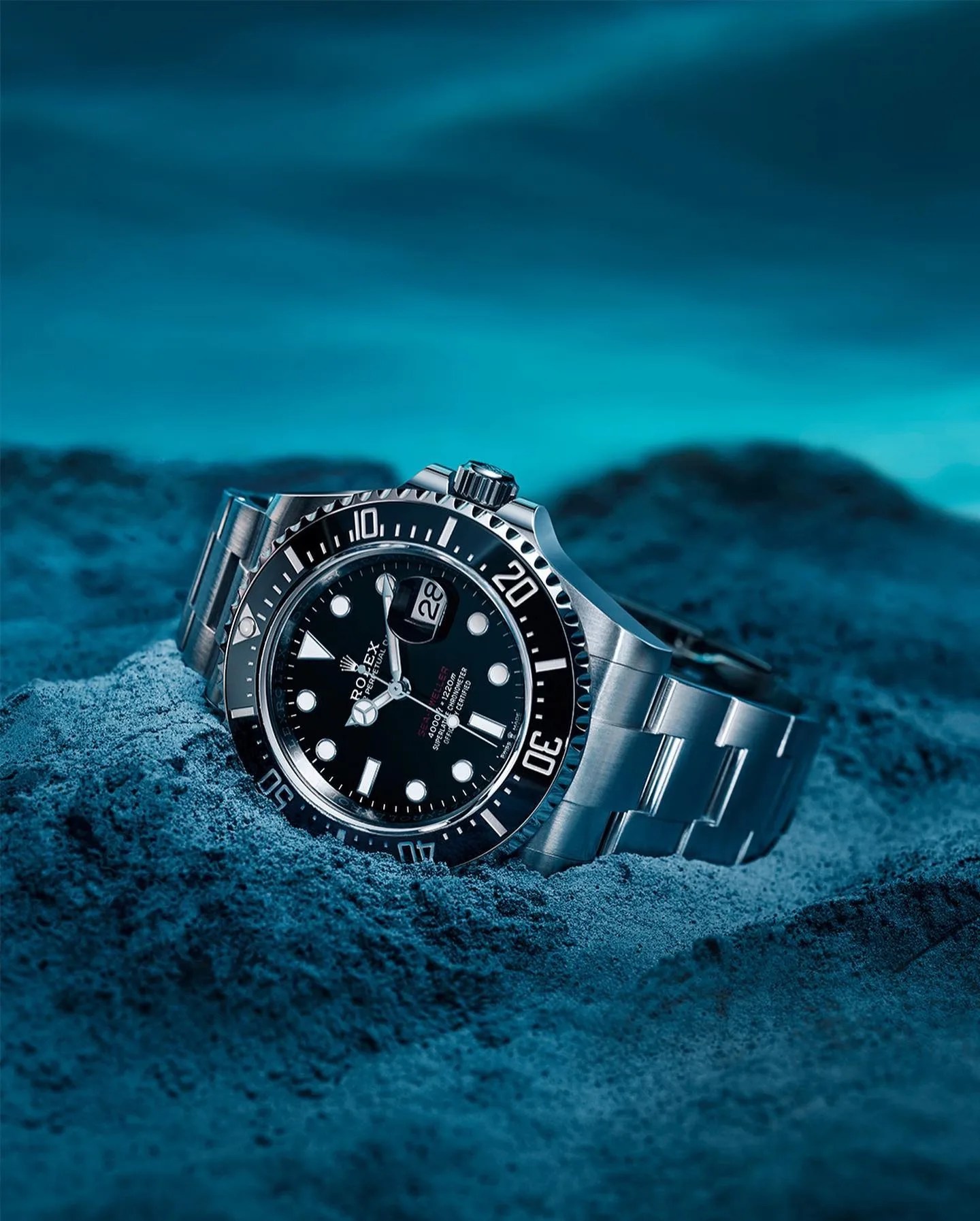 rolex dive watch on the ocean floor