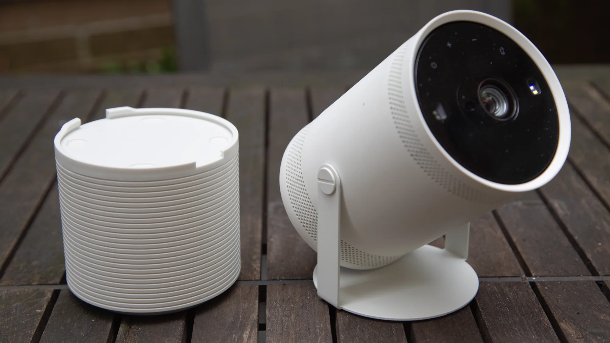 white samsung freestyle projector with separate battery pack base