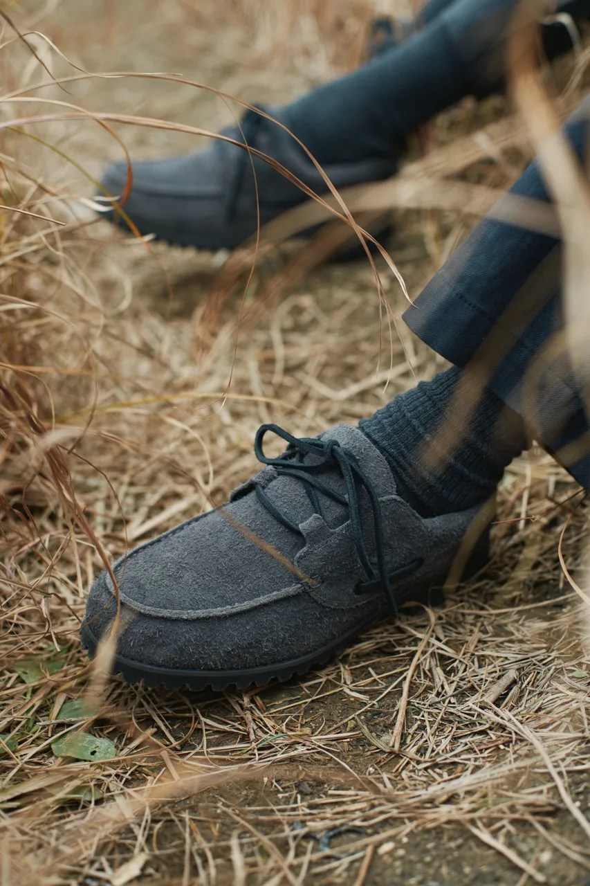 timberland x white mountaineering boat shoes in a field