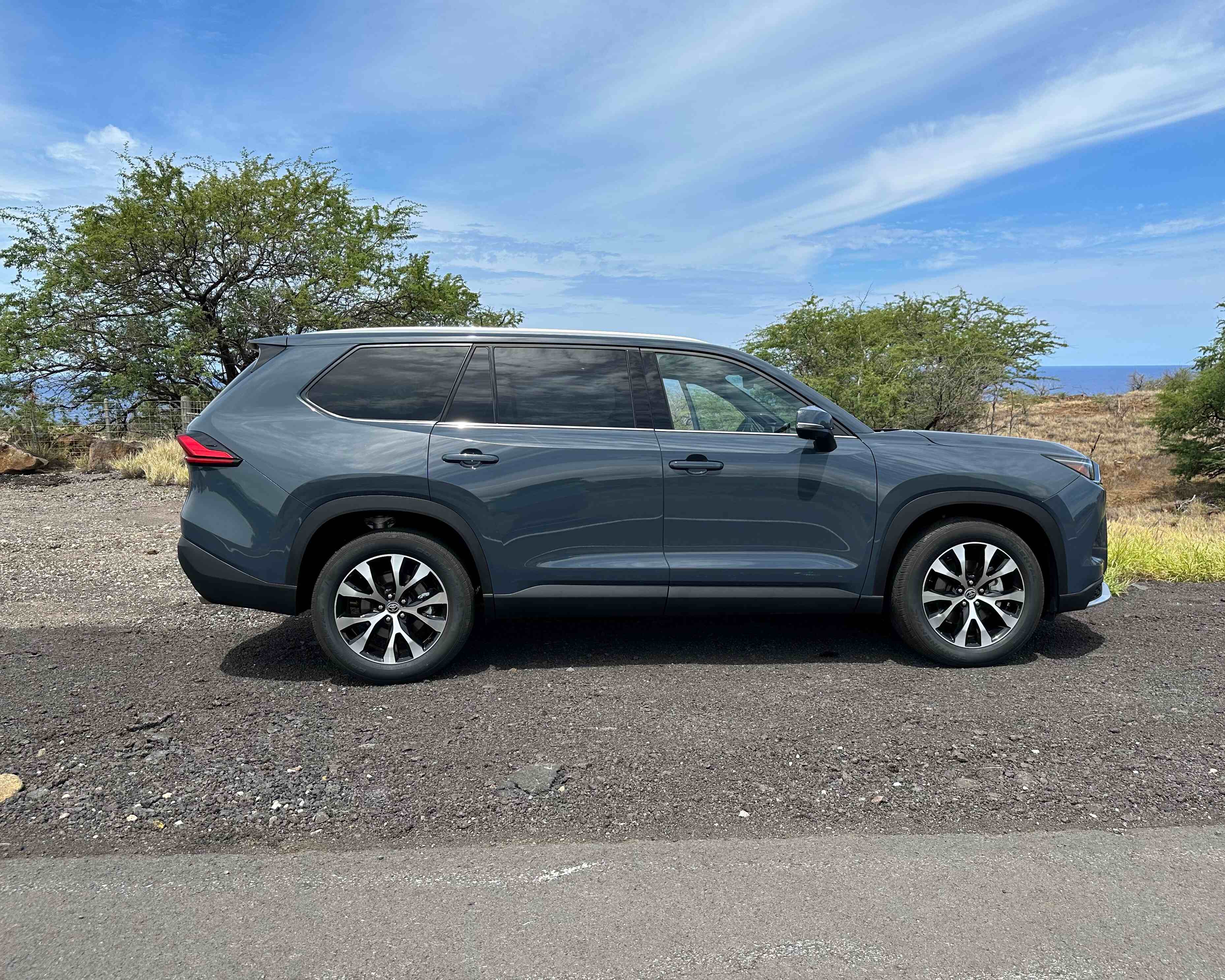 Toyota Grand Highlander parked in front of ocean