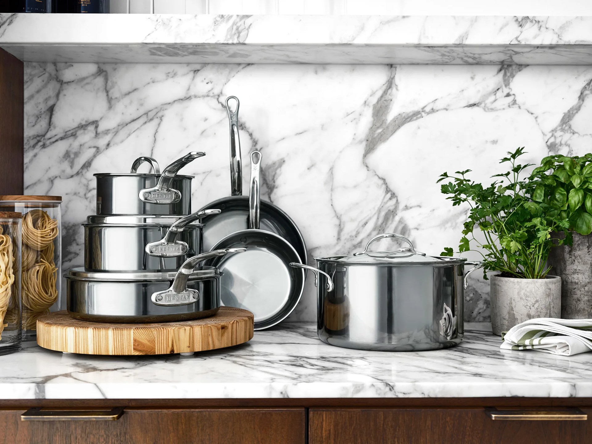 cooking pans on white kitchen wall