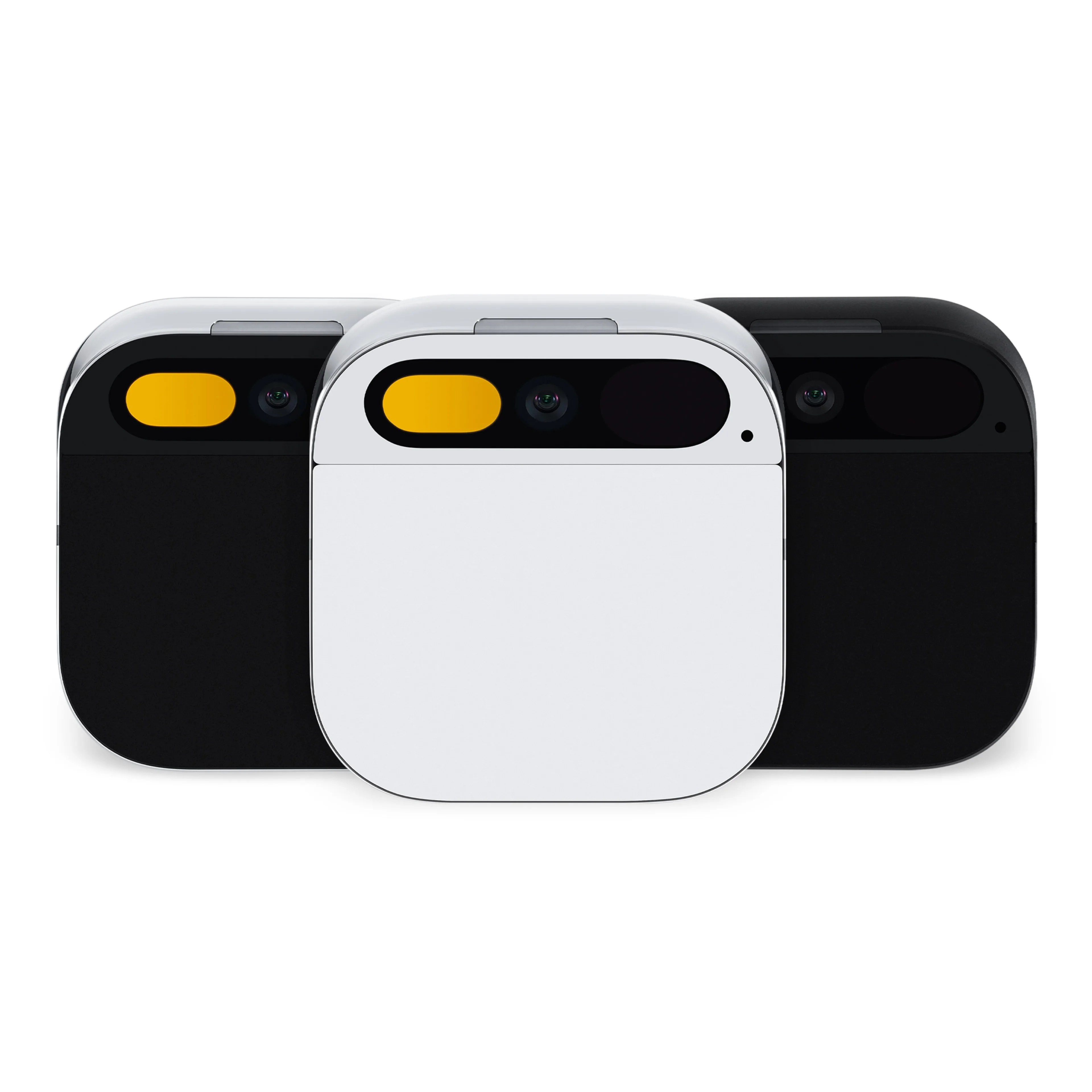 Three humane AI pins, two in black, one in white, lined up on a white background. 