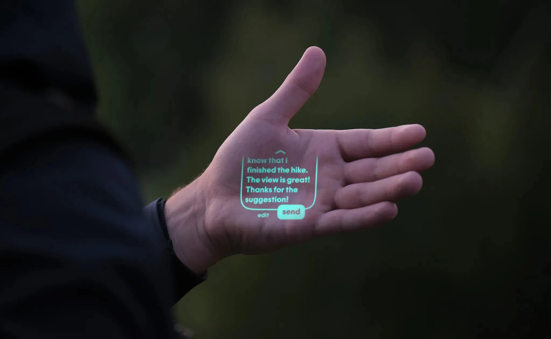 Humane AI pin projection interface shown on palm of hand. It includes a text message with buttons for sending responses. 