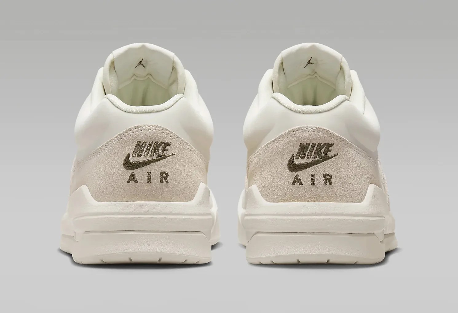 Pair Jordan Stadium 90 sneakers in sail/off-whilte color on grey shown from back