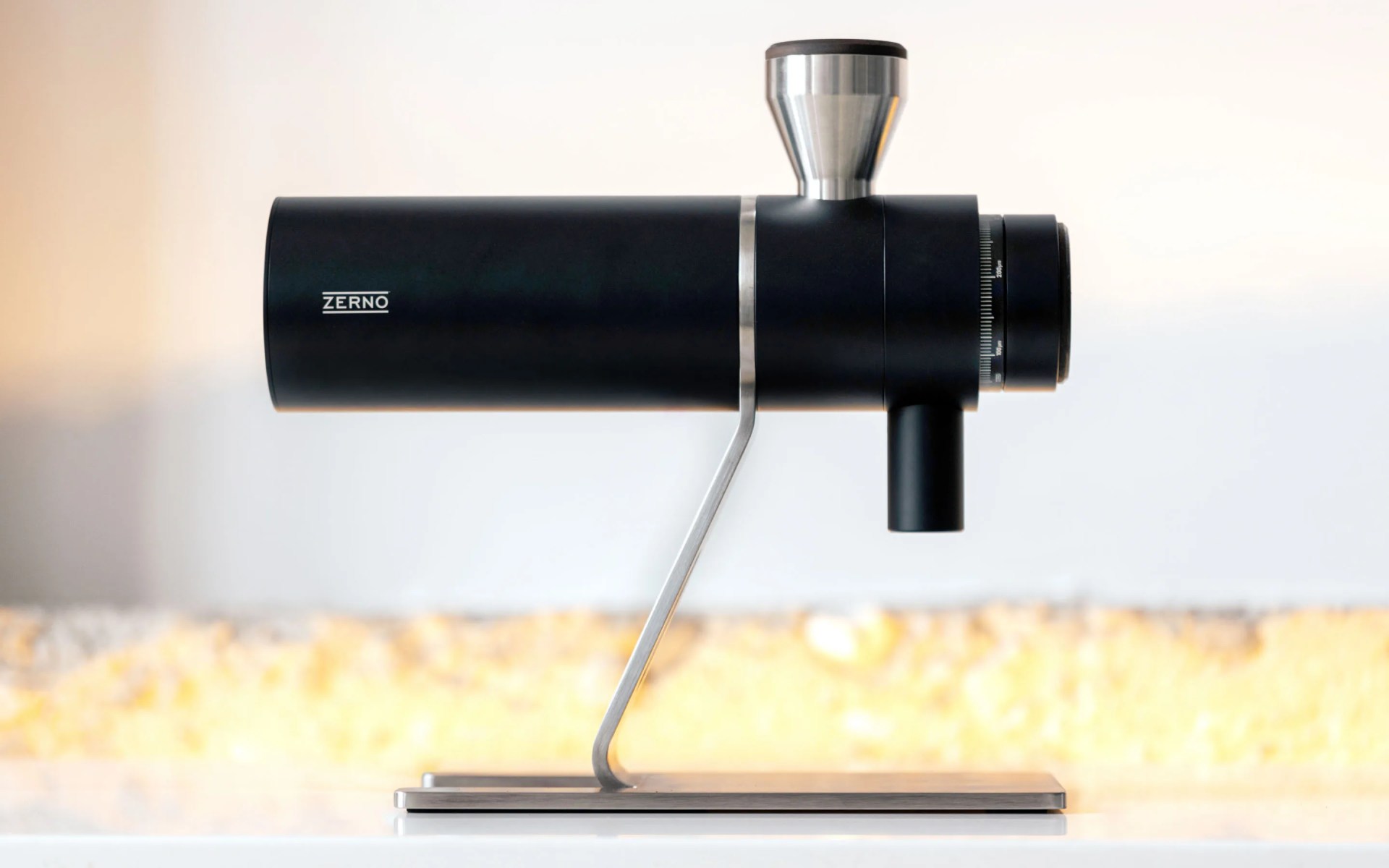 Zerno Z1 coffee grinder shown sitting on table from a side profile view.
