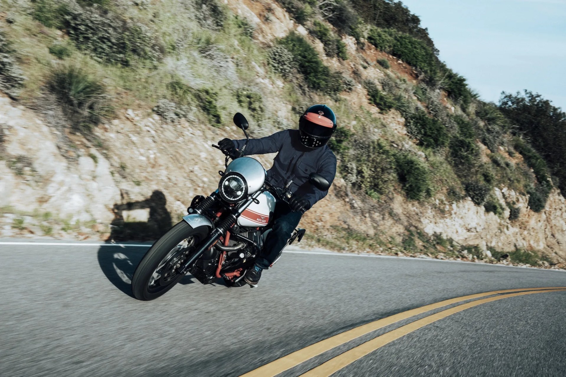 rider wearing aether mulholland moto jacket on moto guzzi motorcycle