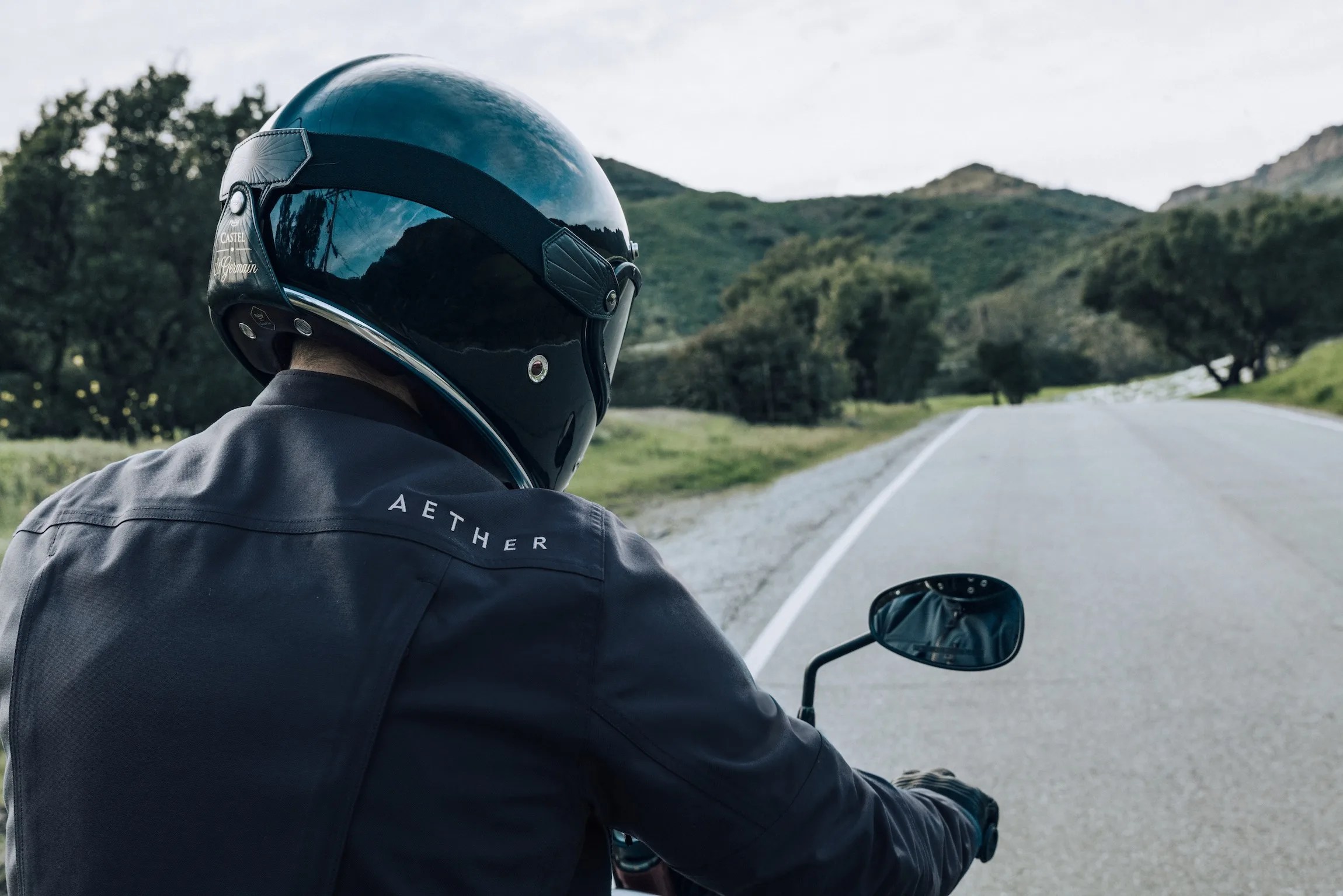 rider wearing aether mulholland moto jacket on moto guzzi motorcycle