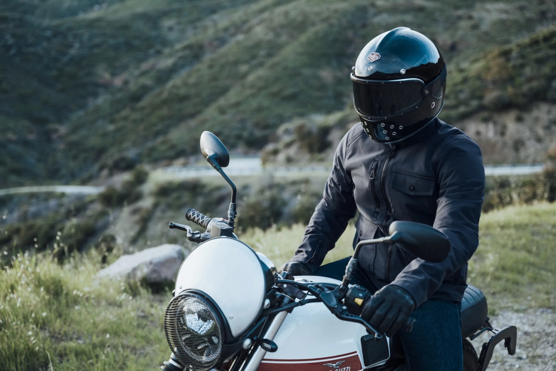 rider wearing aether mulholland moto jacket on moto guzzi motorcycle