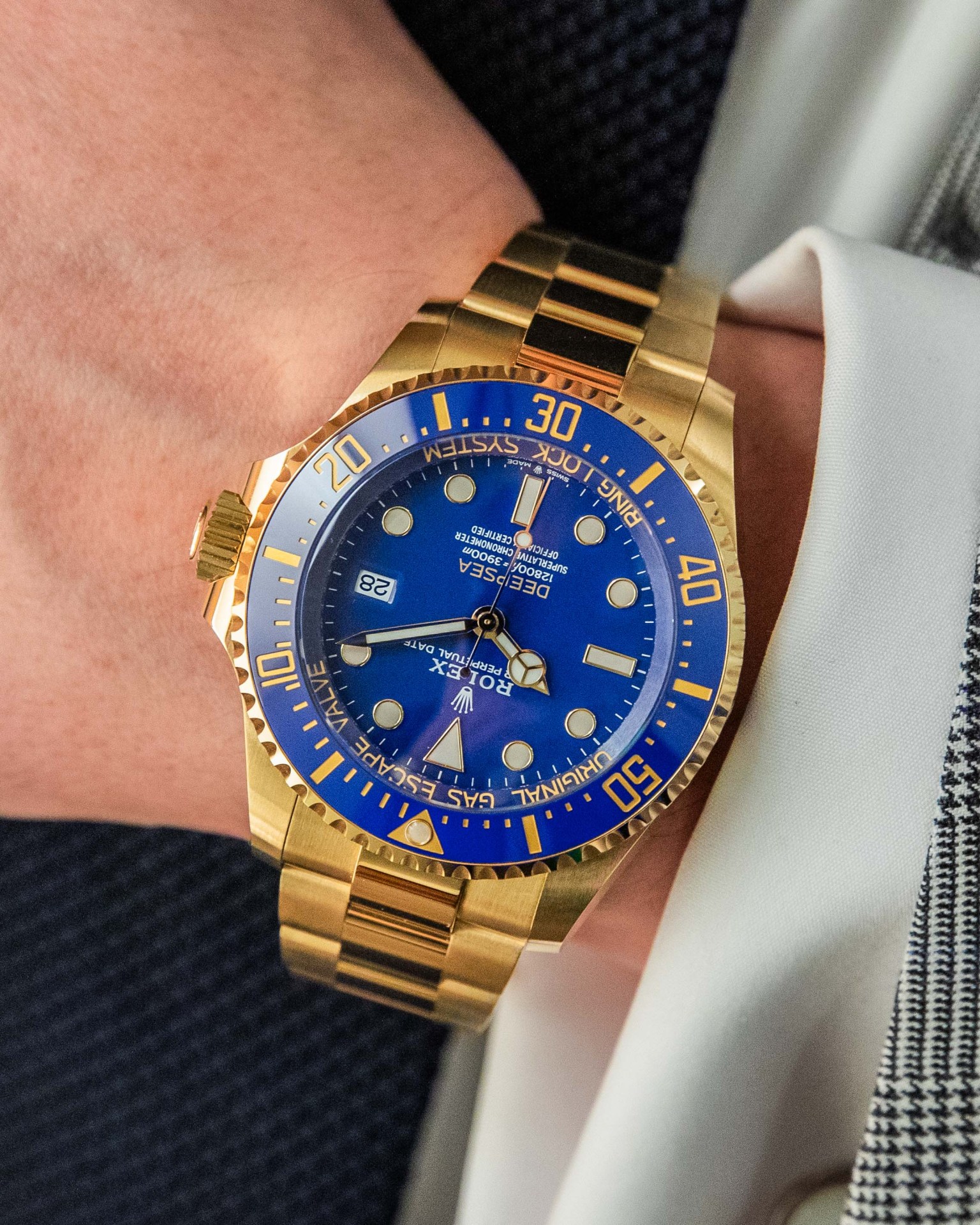 photo of gold rolex with blue dial on man's wrist