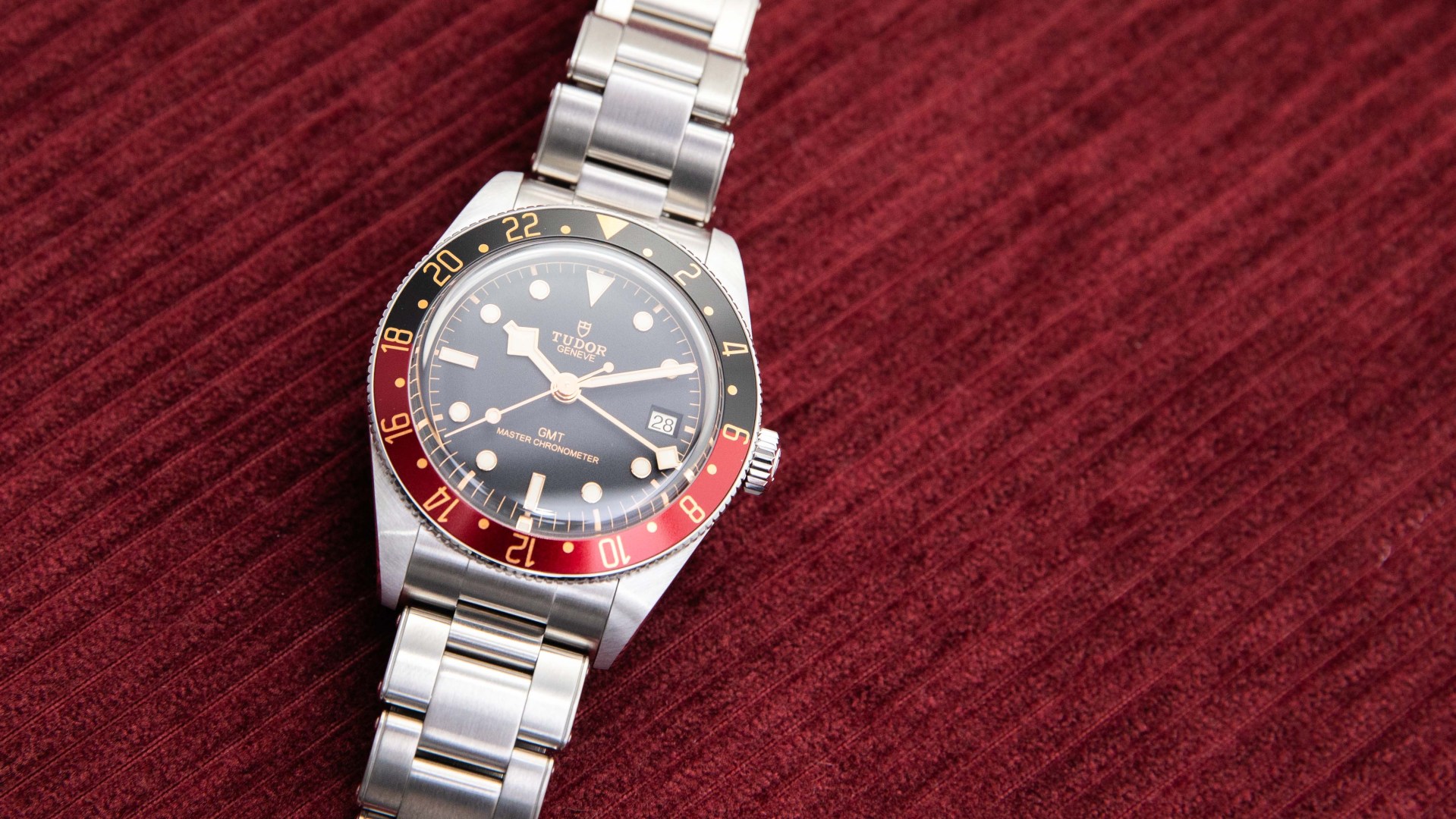 photo of gmt watch on red velvet background