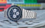 blue timex chronograph watch lying on a crossword puzzle