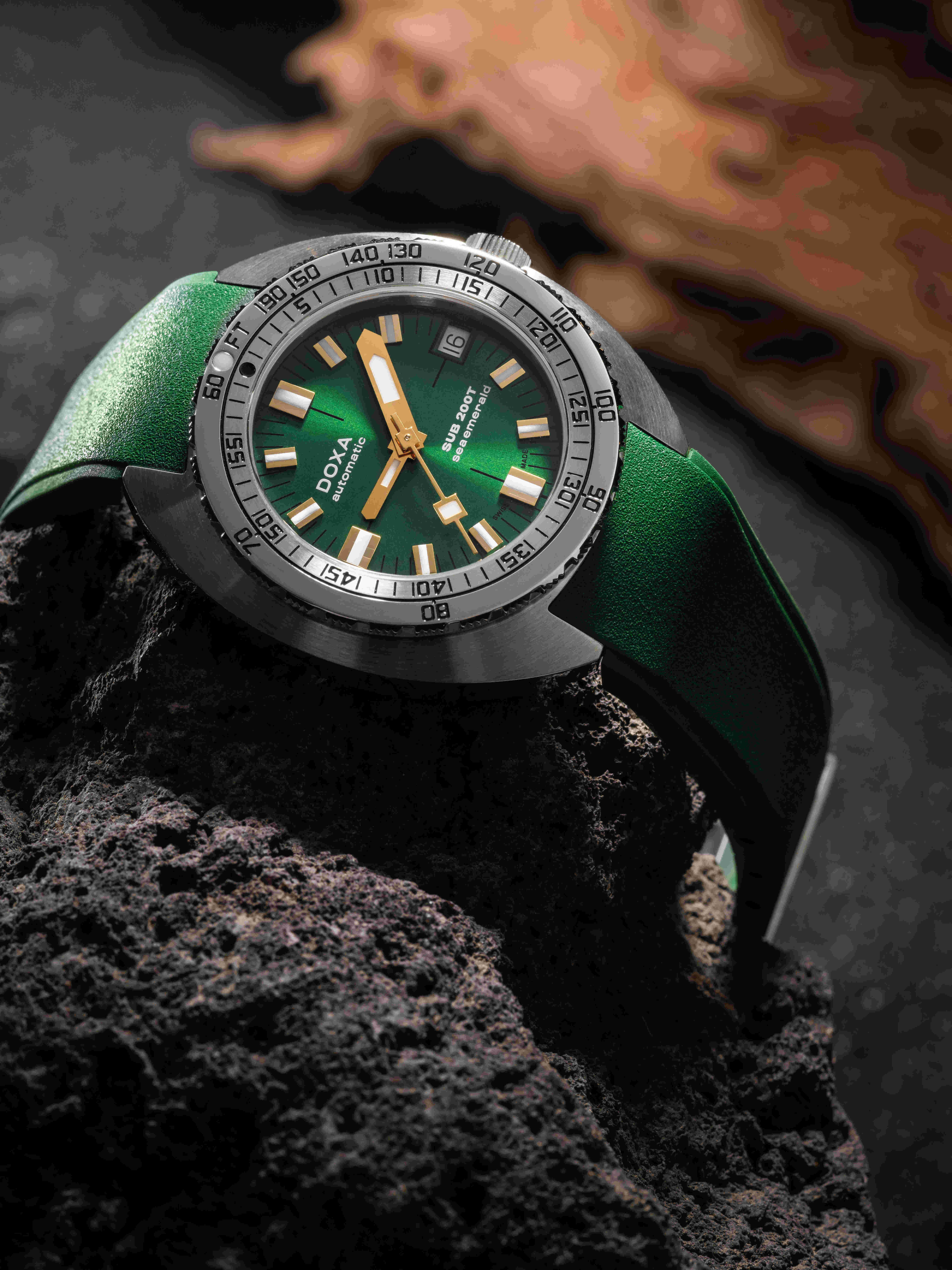 Green doxa dive watch on a rock