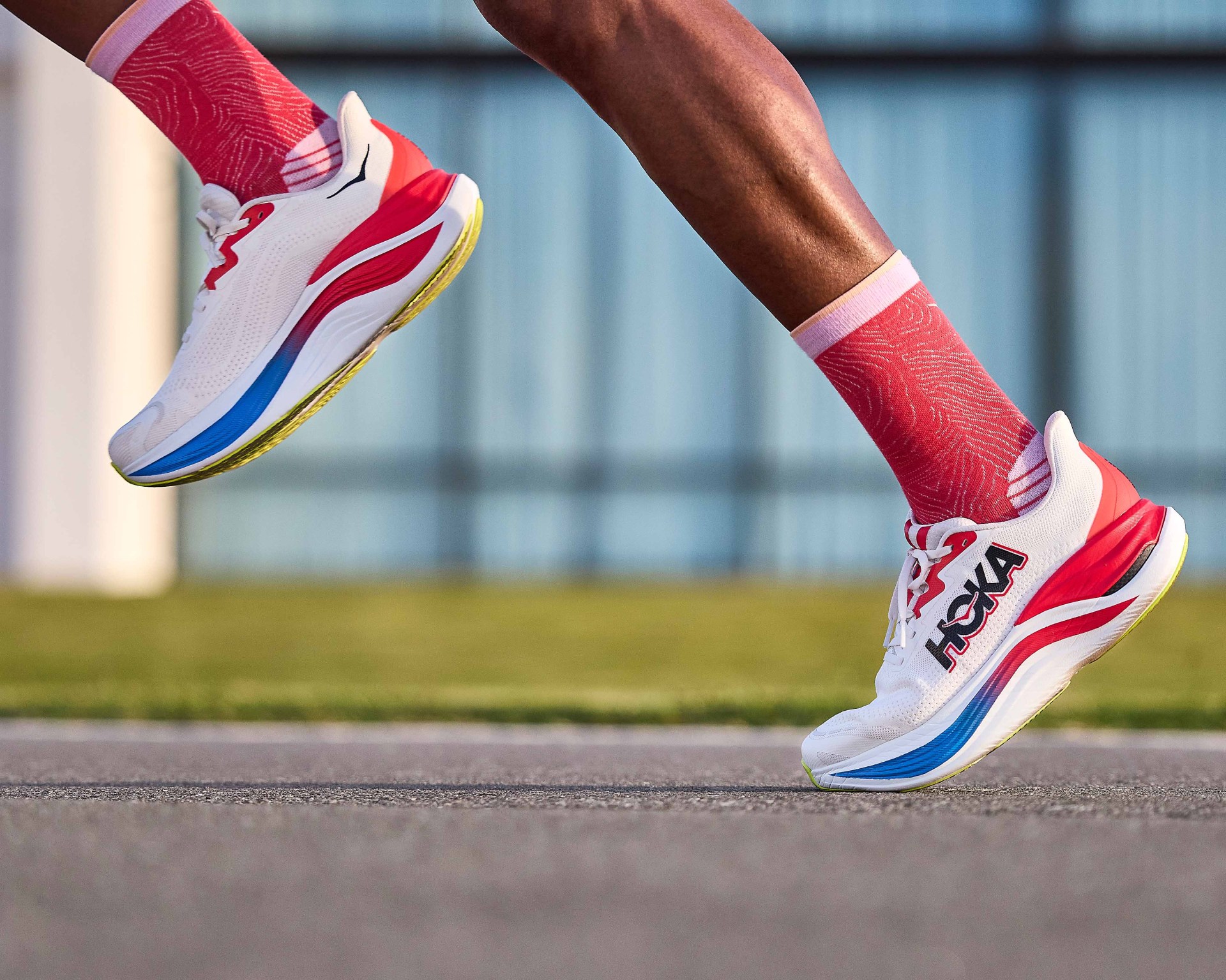 man running in a pair of hoka running shoes