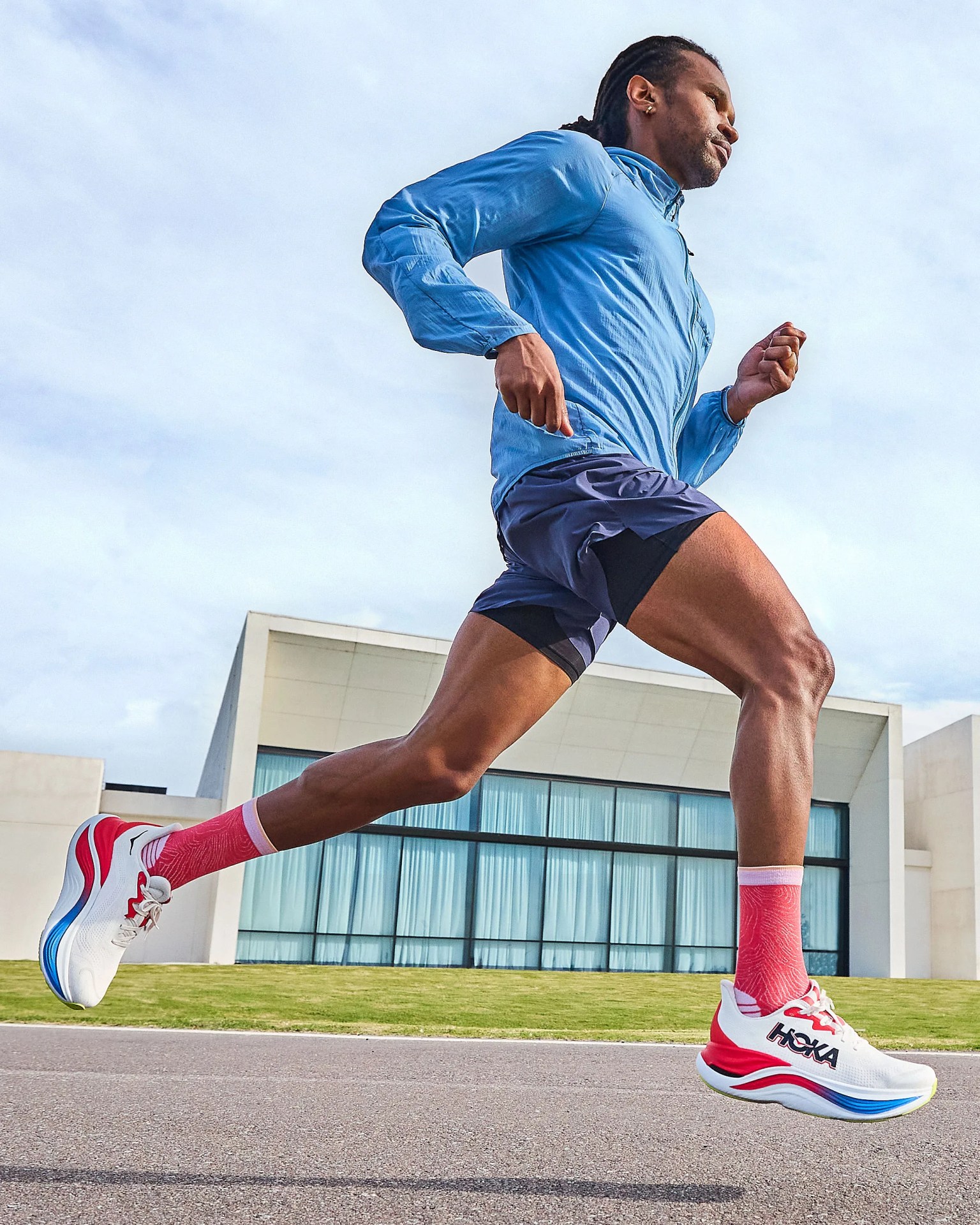 man running in pair of hoka shoes