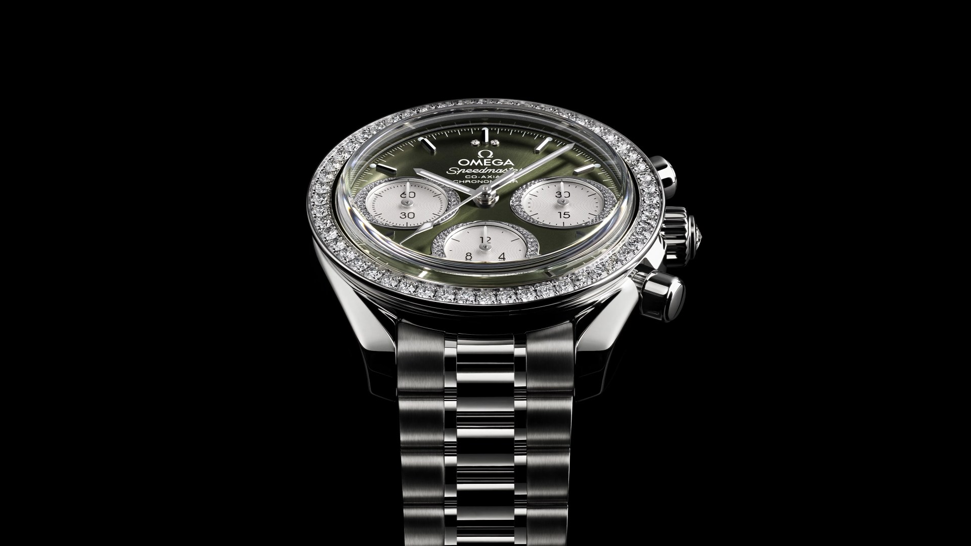 a diamond encrusted omega speedmaster watch against a black background