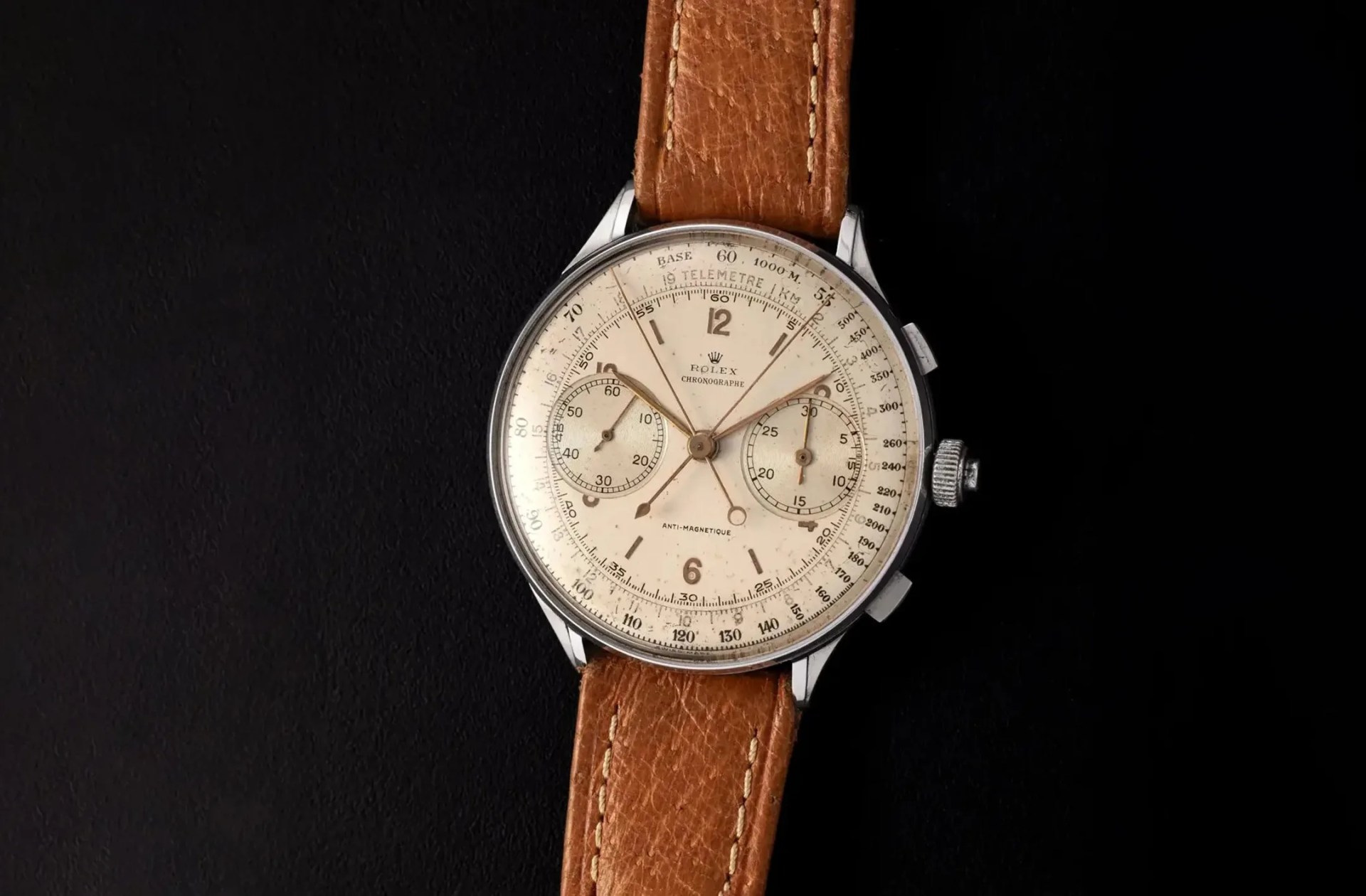 vintage rolex watch against a black background