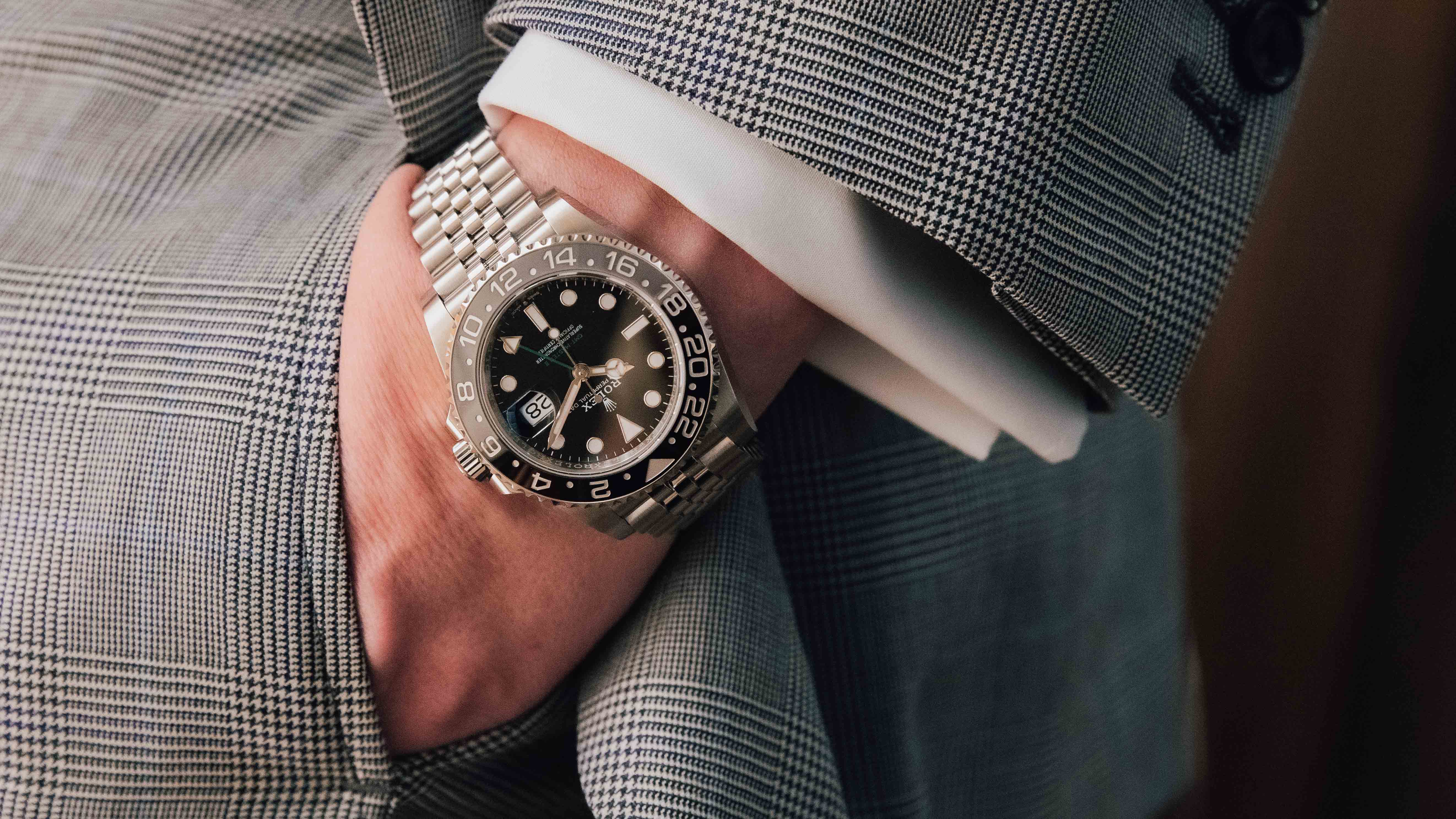 steel rolex watch on man's wrist