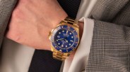 gold rolex watch and man's wrist