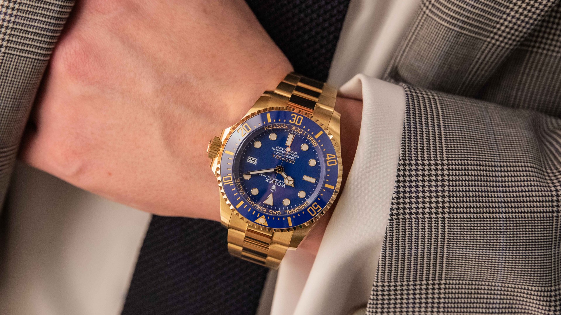 gold rolex watch and man's wrist