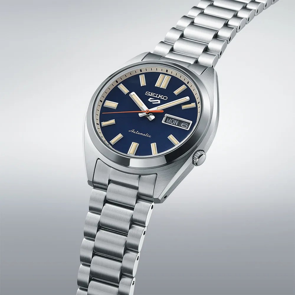 blue seiko watch against a white and gray backdrop