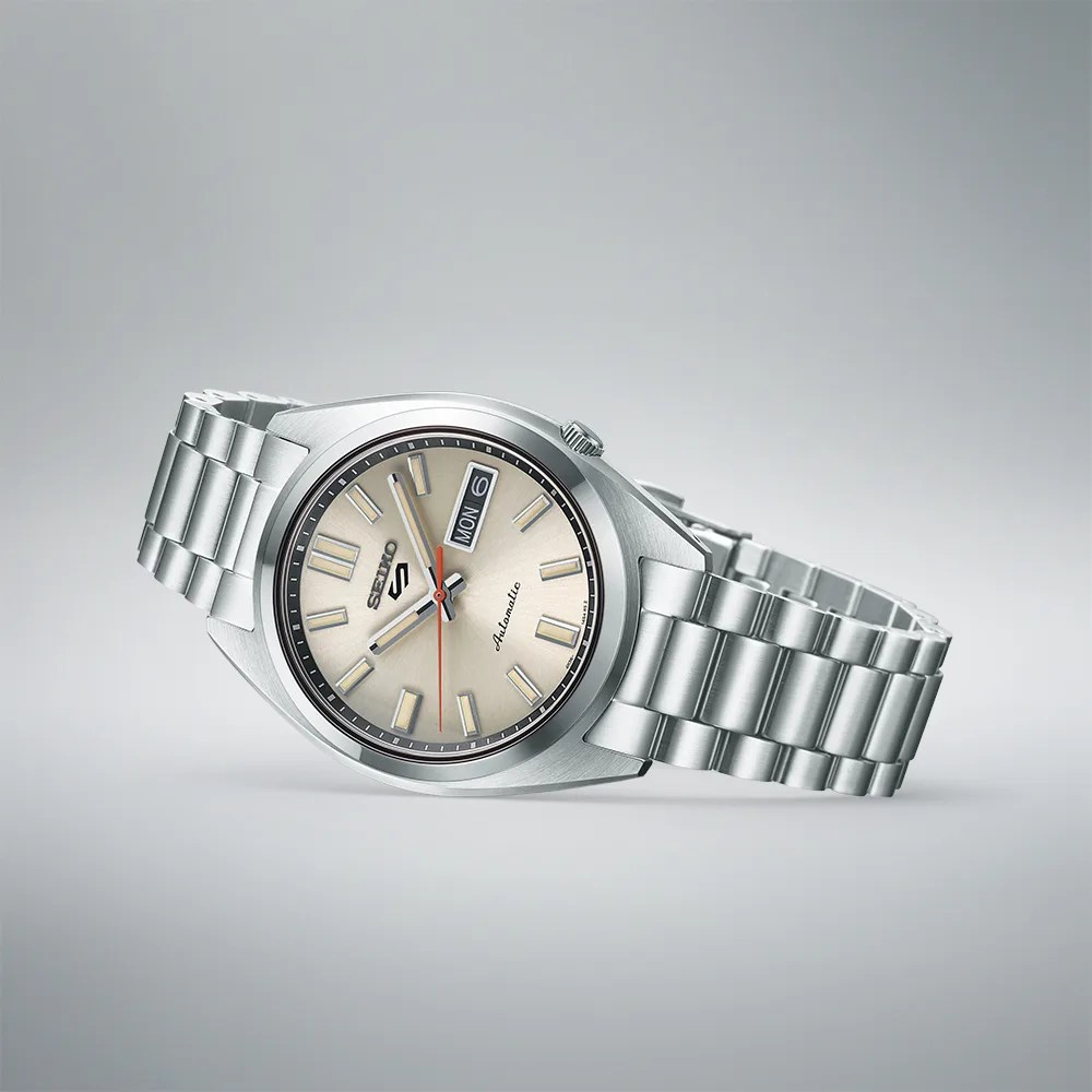 seiko watch with cream dial lying on its side