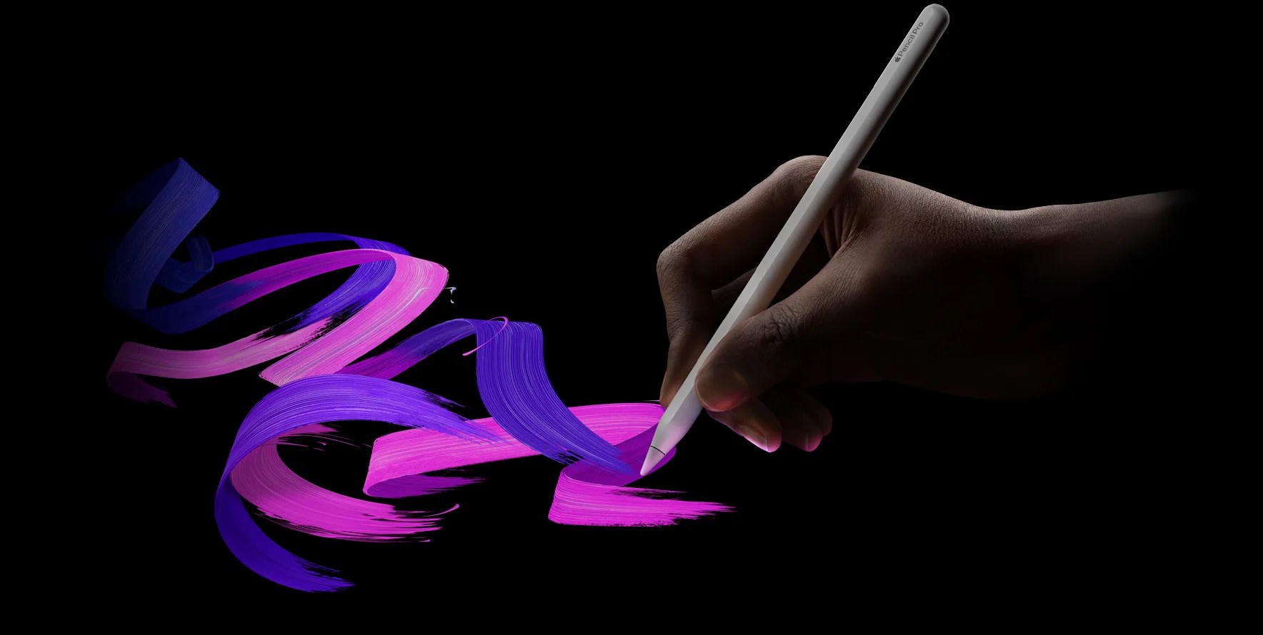 Image of Apple Pencil Pro sketching vibrant pink and purple lines on a black background. 