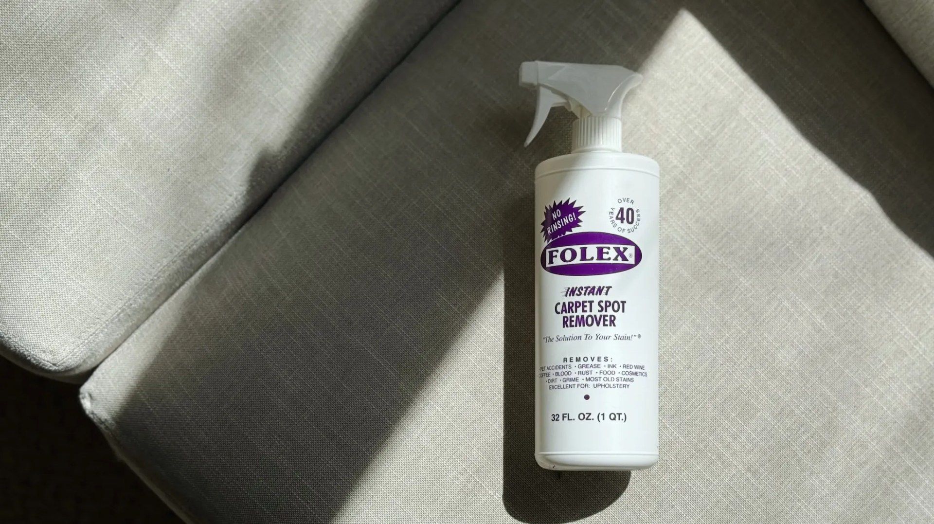 Bottle of Folex Carpet cleaning solution on grey background