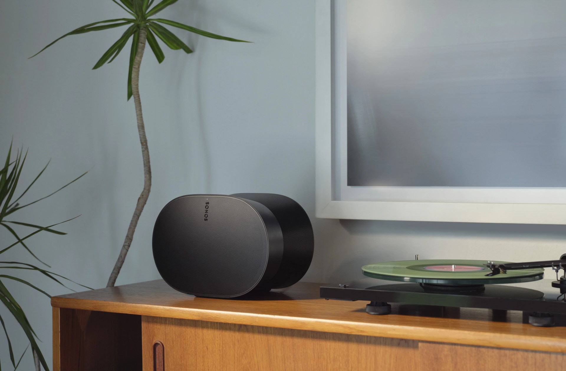 Sonos Era 300 sitting on sideboard next to vinyl turntable