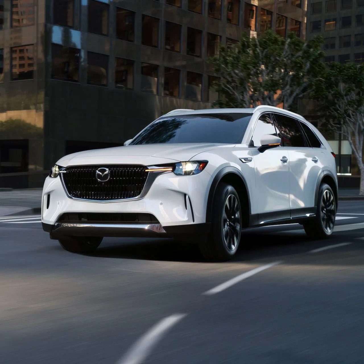 a white 2020 mazda cx 9 driving down a city street