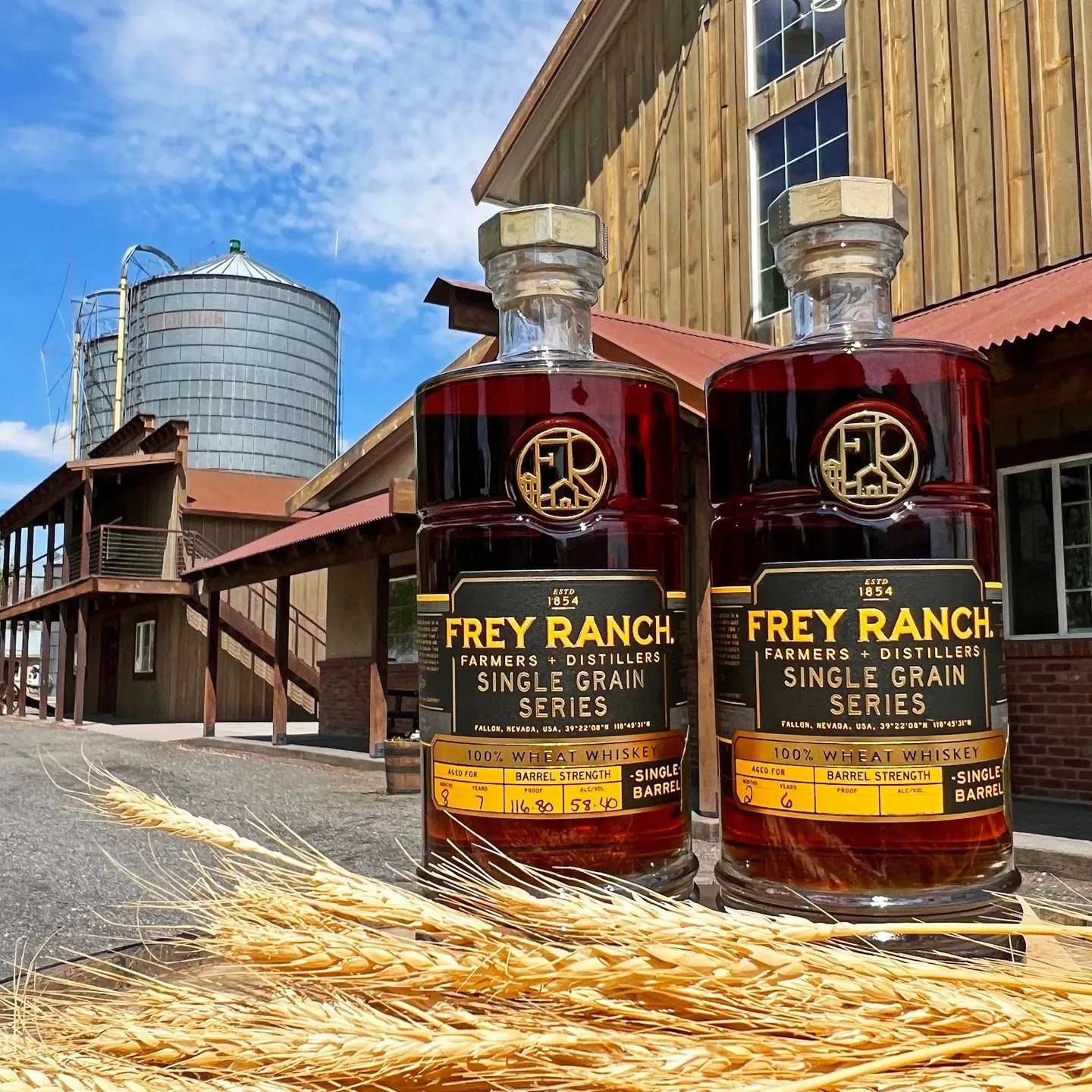 two frey ranch whiskey bottles on some wheat