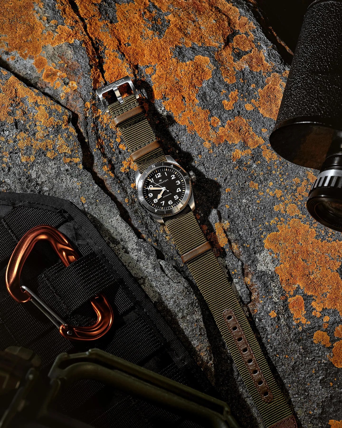 watch laying flat on rock with hiking gear