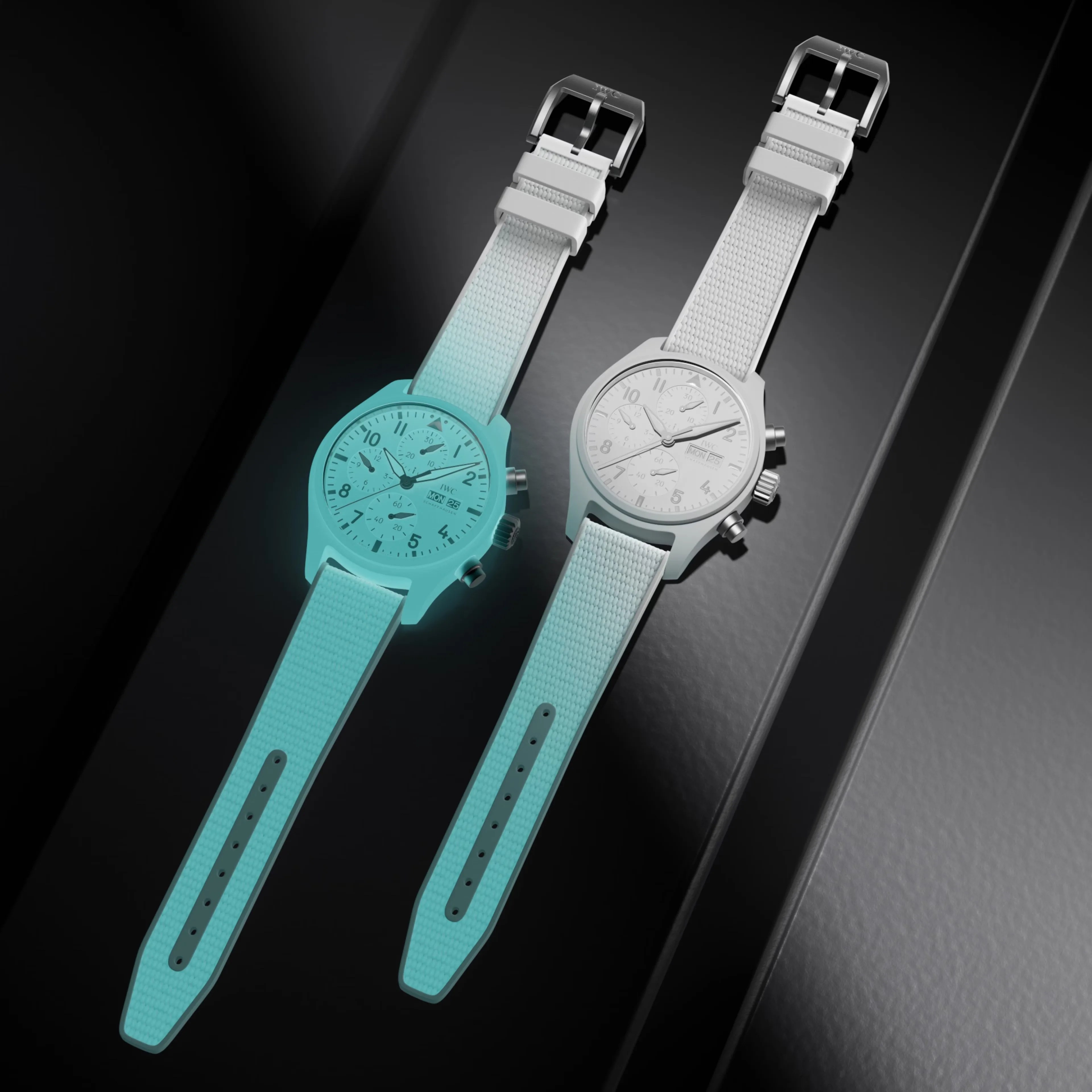 two white lumed iwc watches lay next to each other