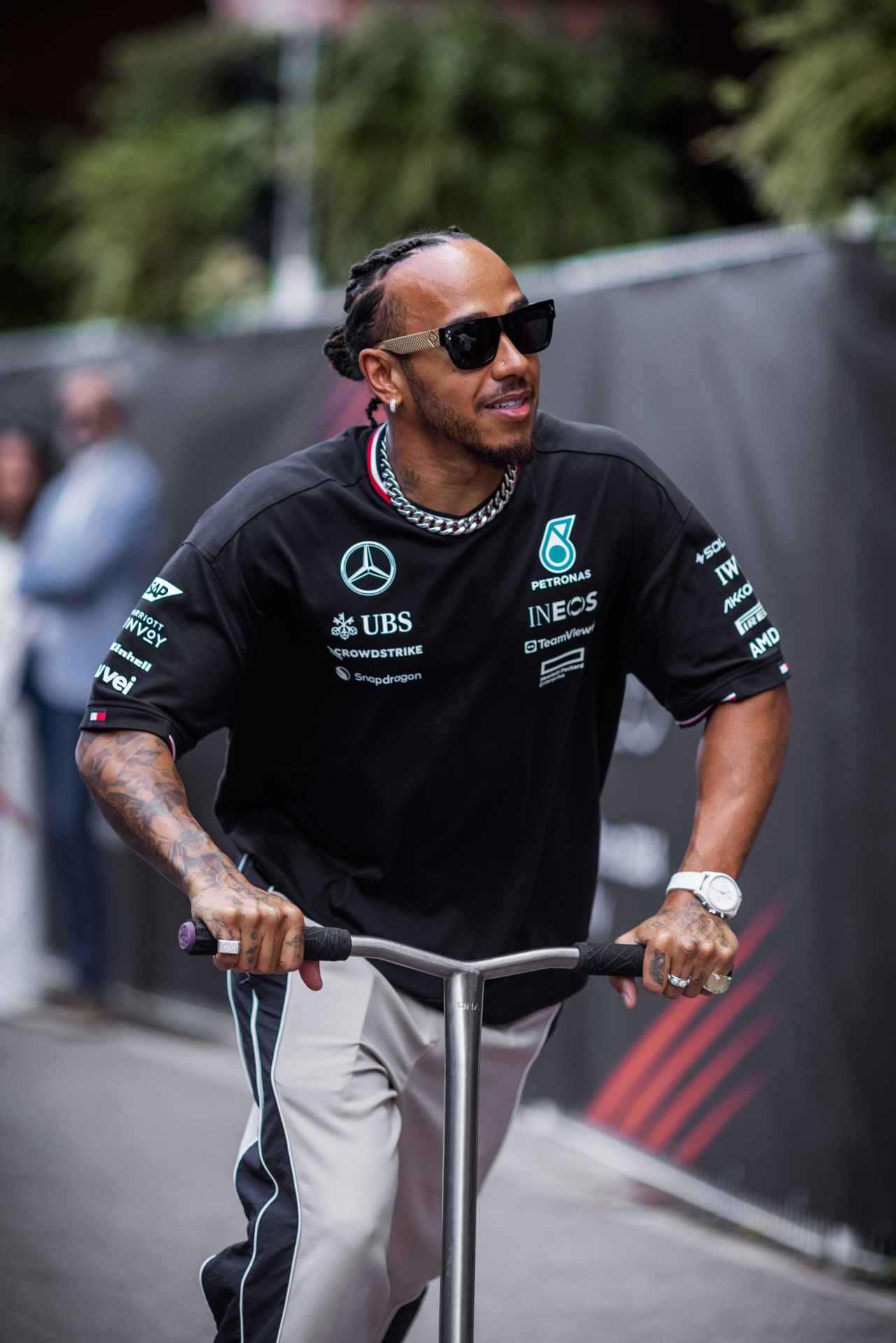 lewis hamilton rides a scooter wearing an iwc watch
