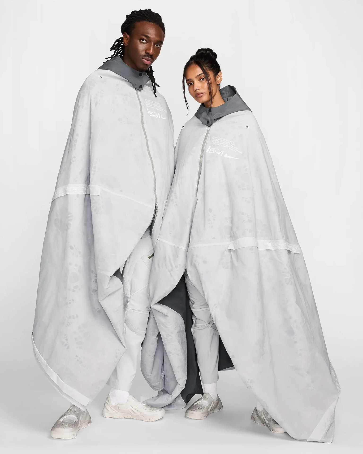 man and woman wearing poncho tents