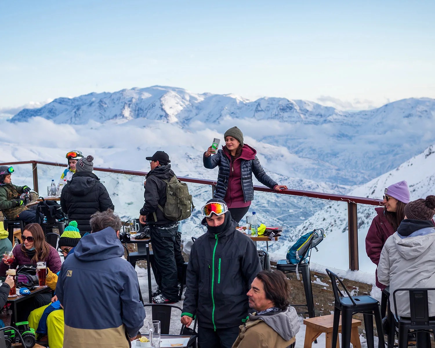 woman on cell phone with snow mountains in background